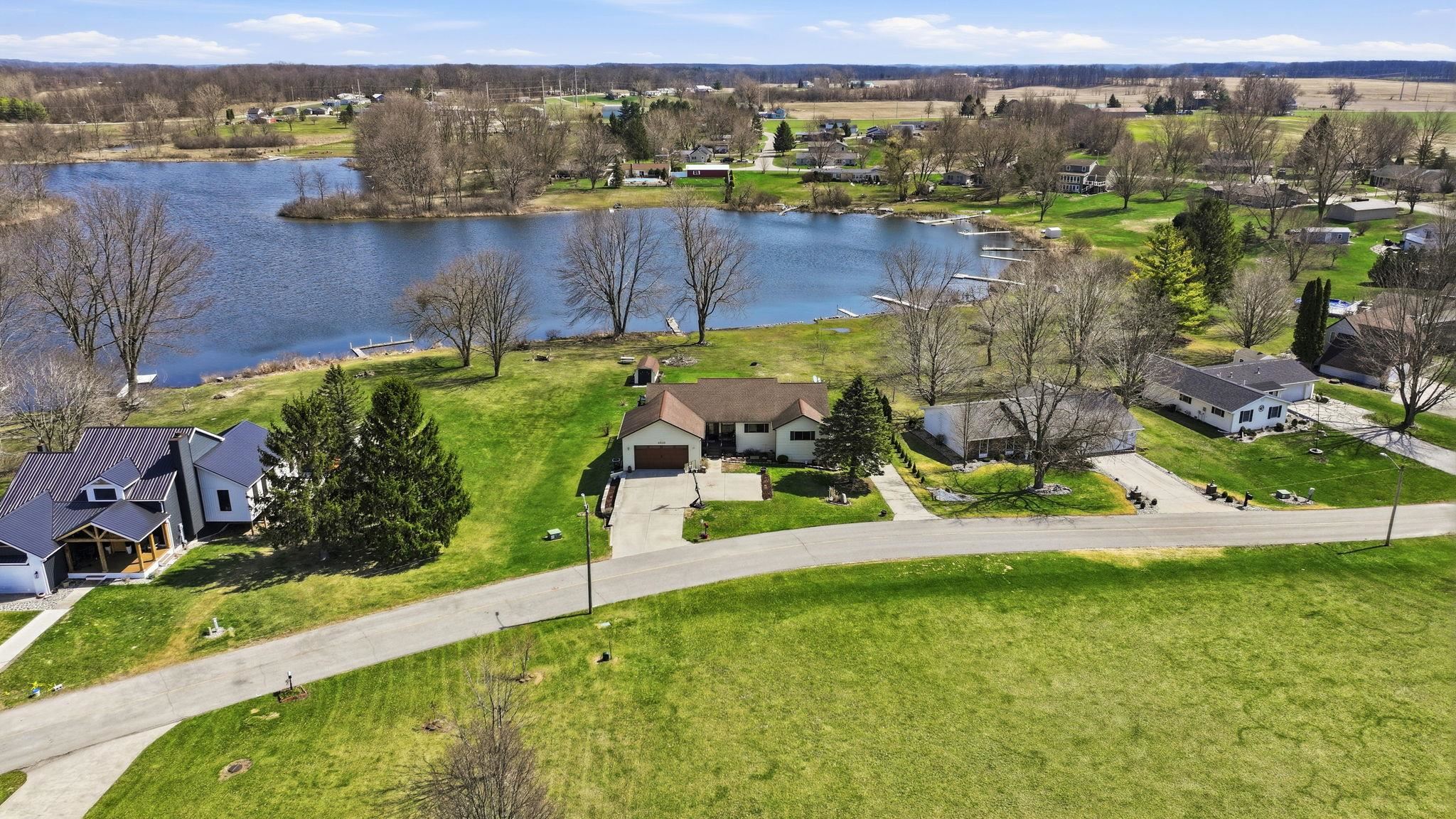 Aerial perspective of suburban area featuring a large body of water