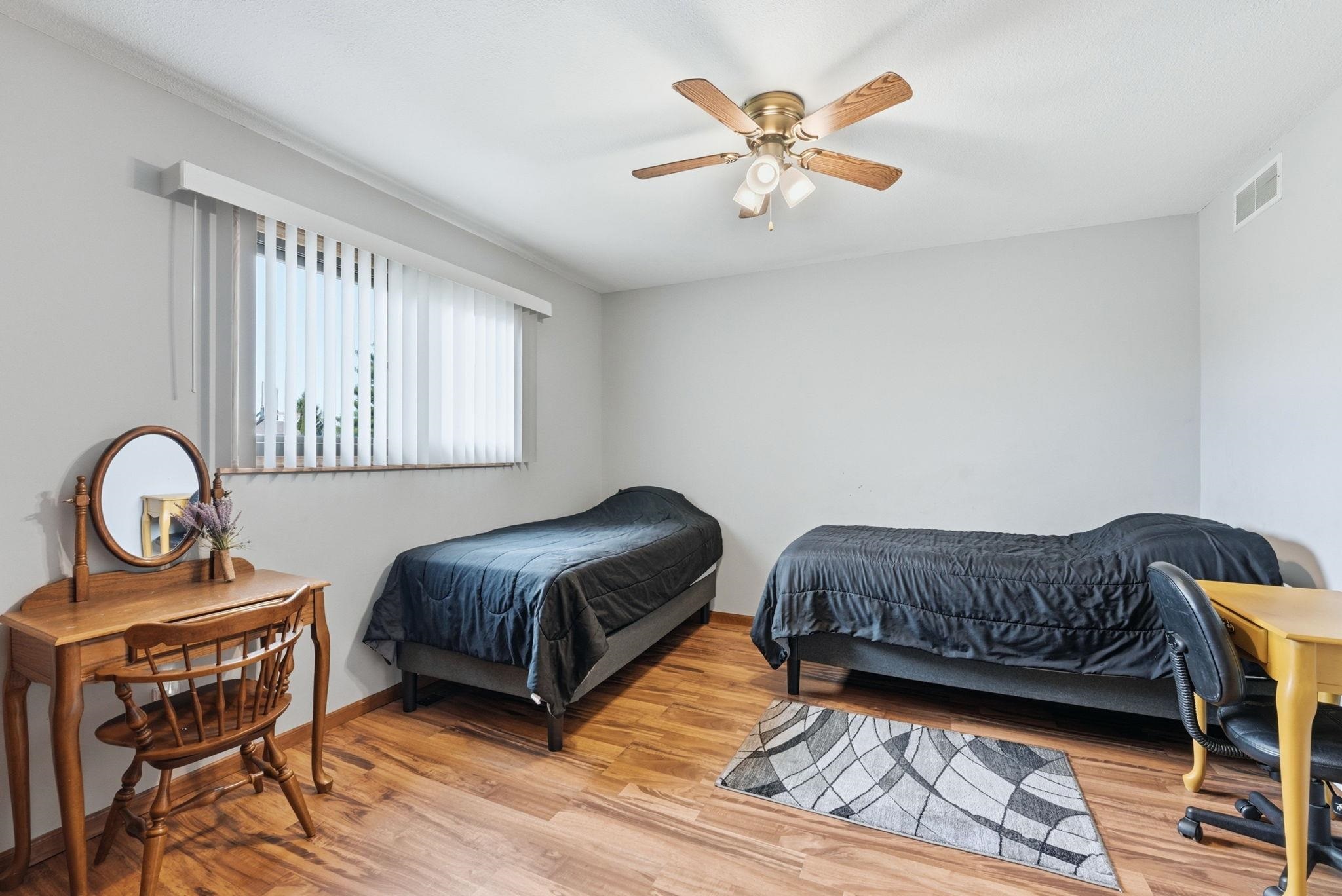 Bedroom featuring light wood finished floors and a ceiling fan