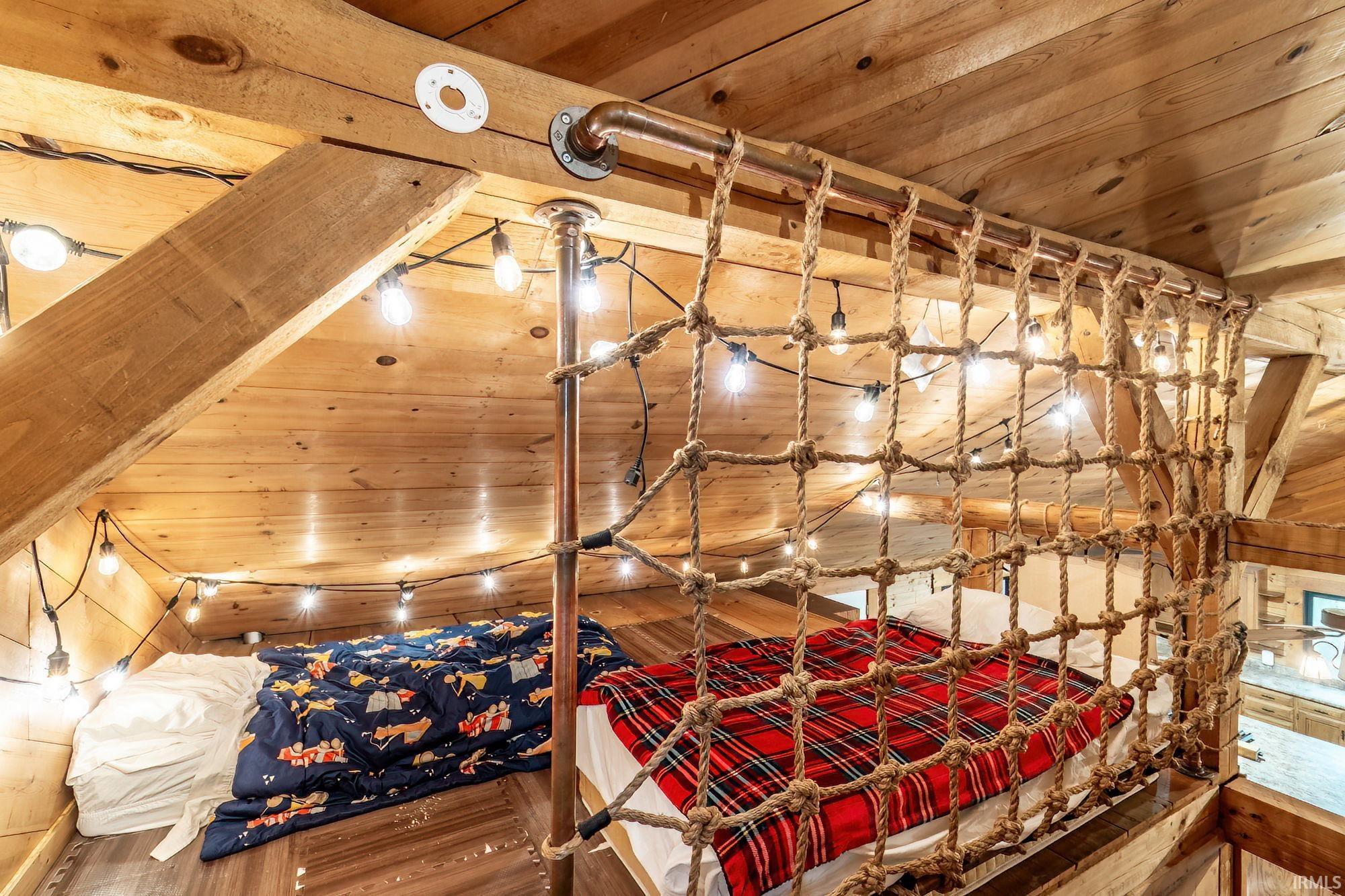 Bedroom with wooden ceiling and wood finished floors