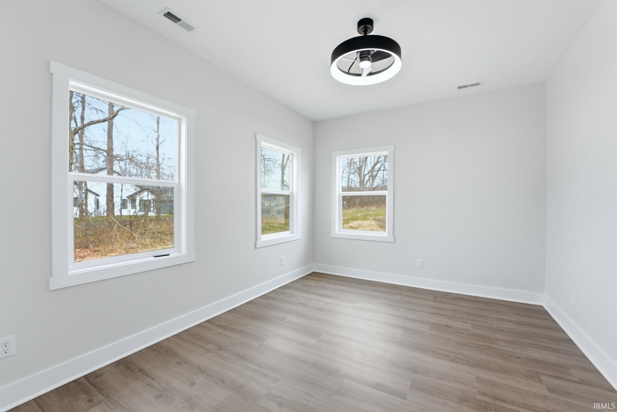Spare room featuring light wood-style flooring and ceiling fan