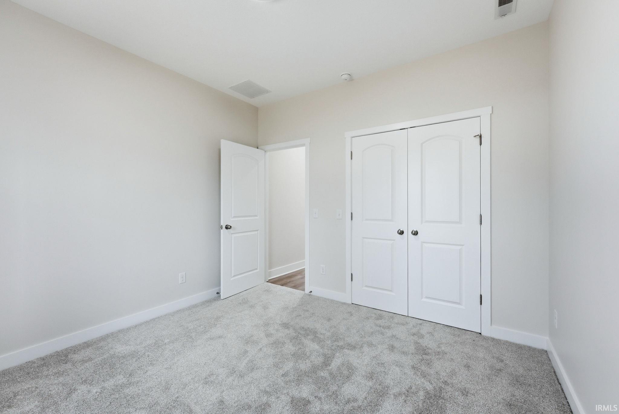 Unfurnished bedroom with carpet floors and a closet