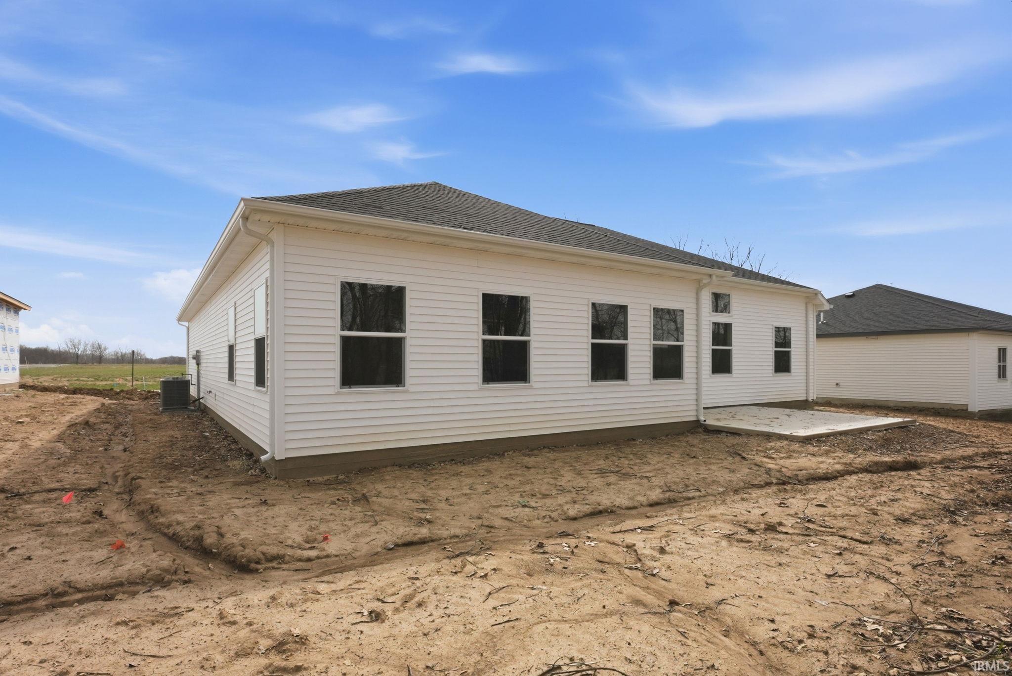 Rear view of property with a patio and a shingled roof
