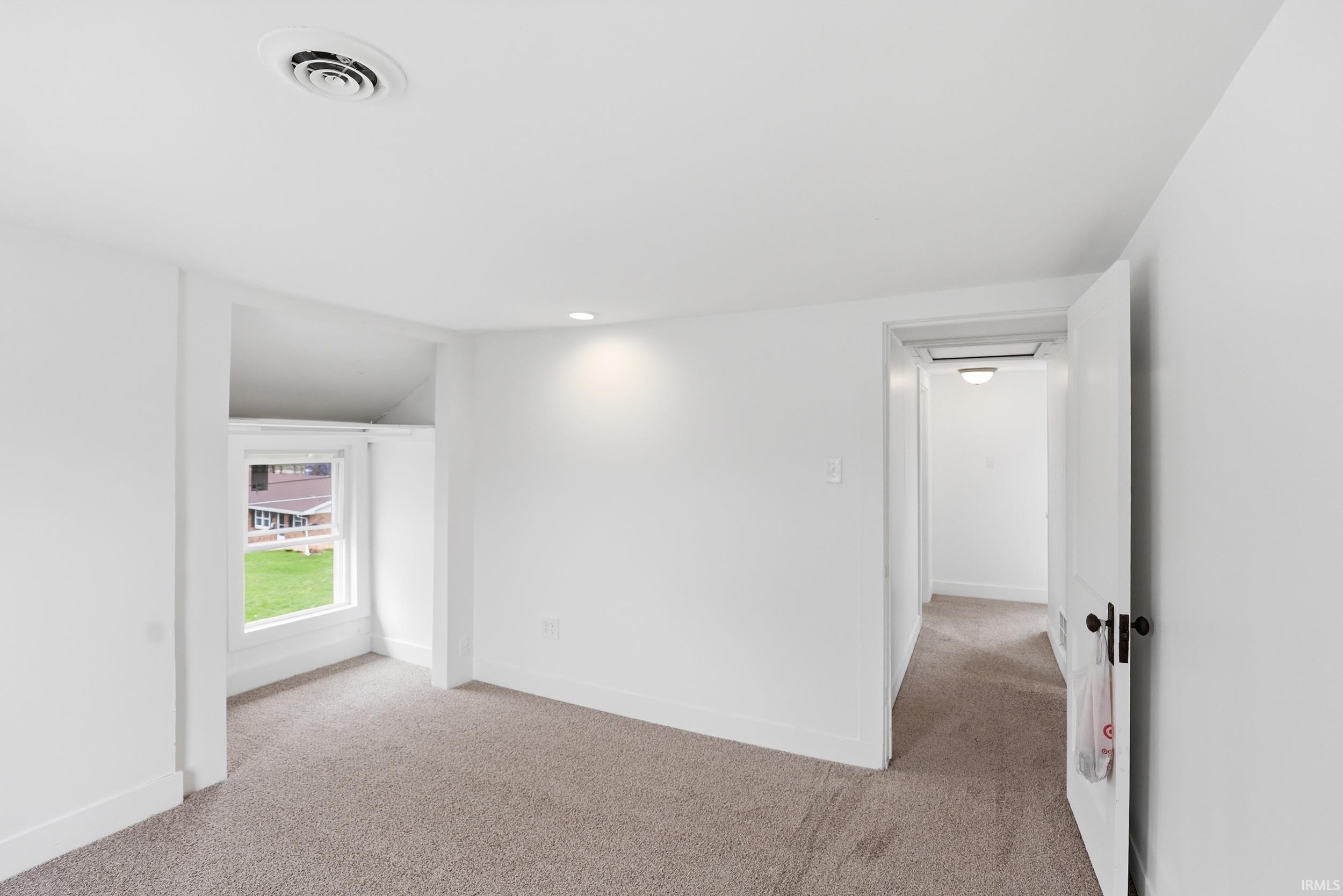 Empty room featuring light carpet and recessed lighting