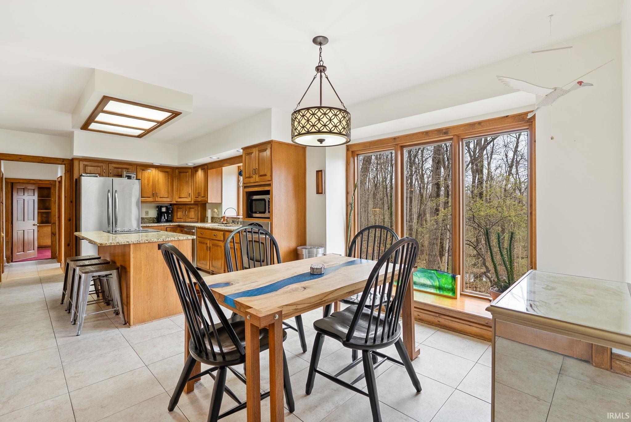 Dining space featuring light tile patterned floors