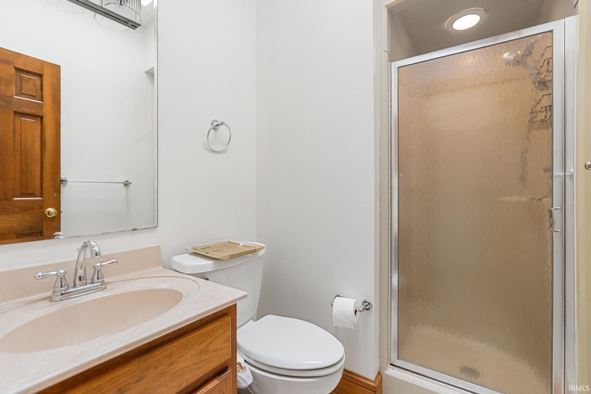 Full bathroom featuring a stall shower and vanity