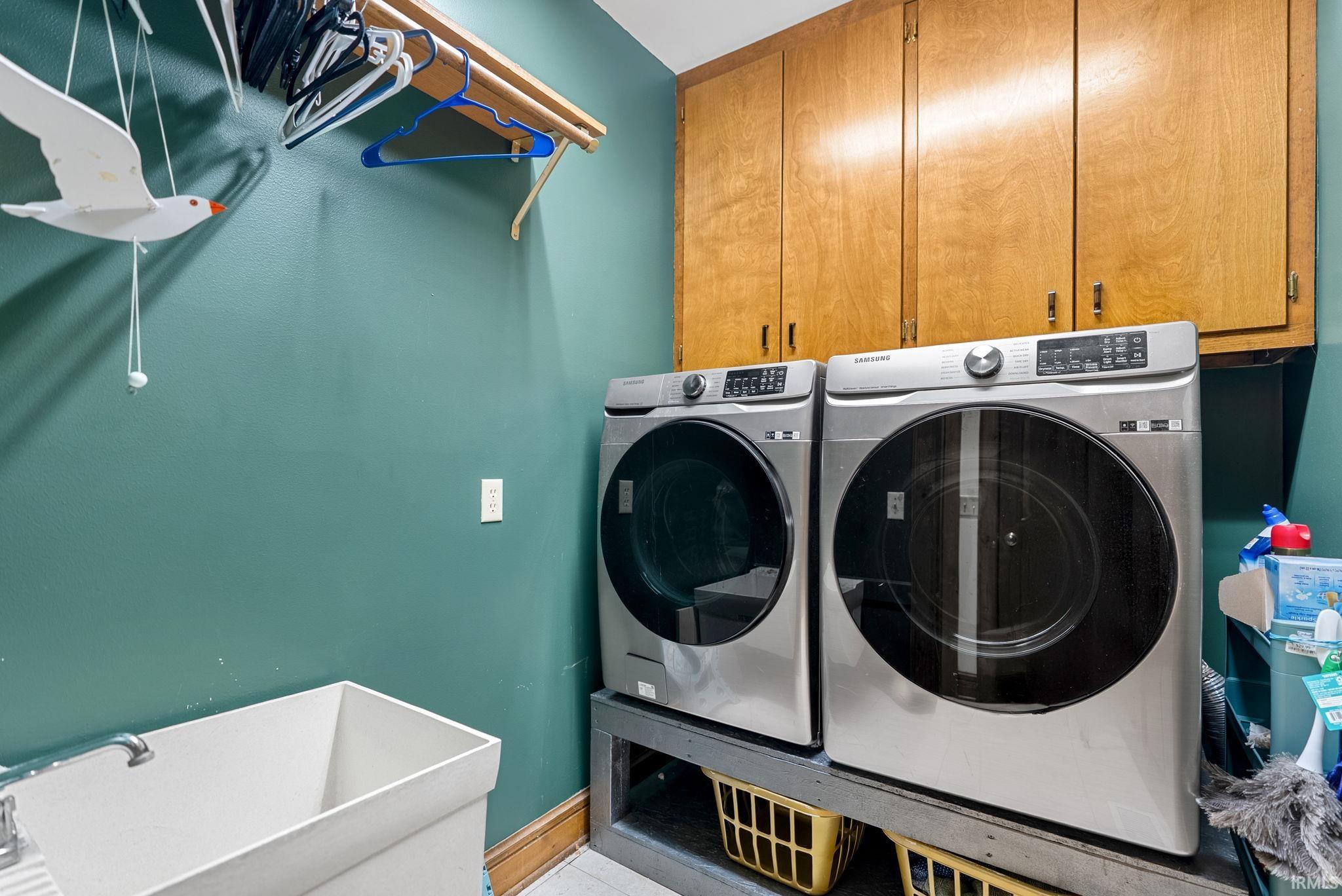 Laundry area featuring cabinet space and washer and dryer