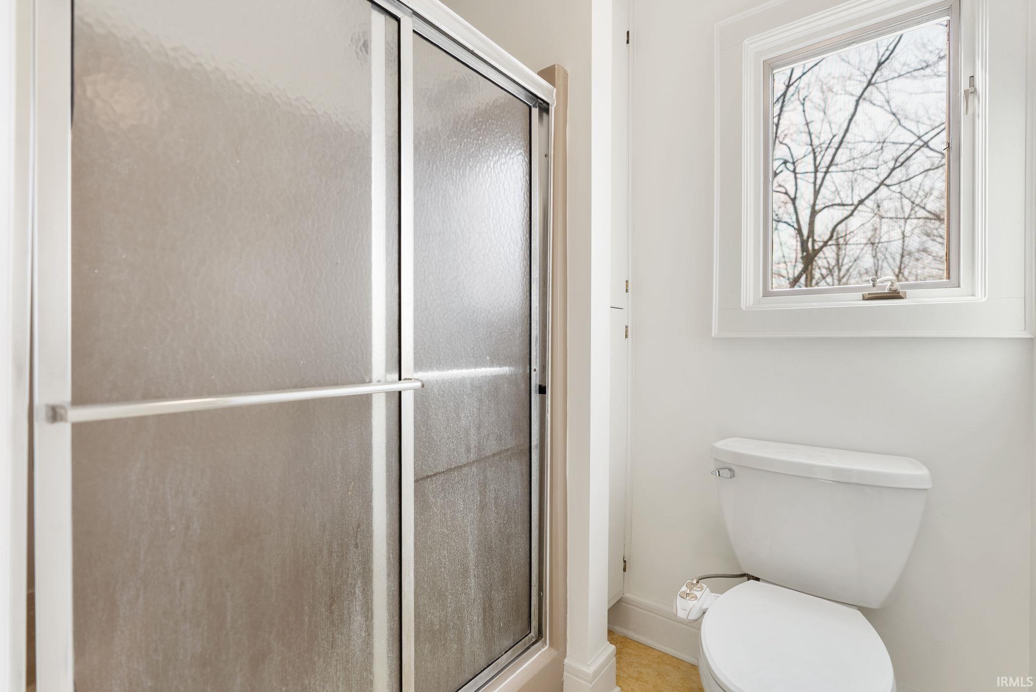 Bathroom with a stall shower and toilet