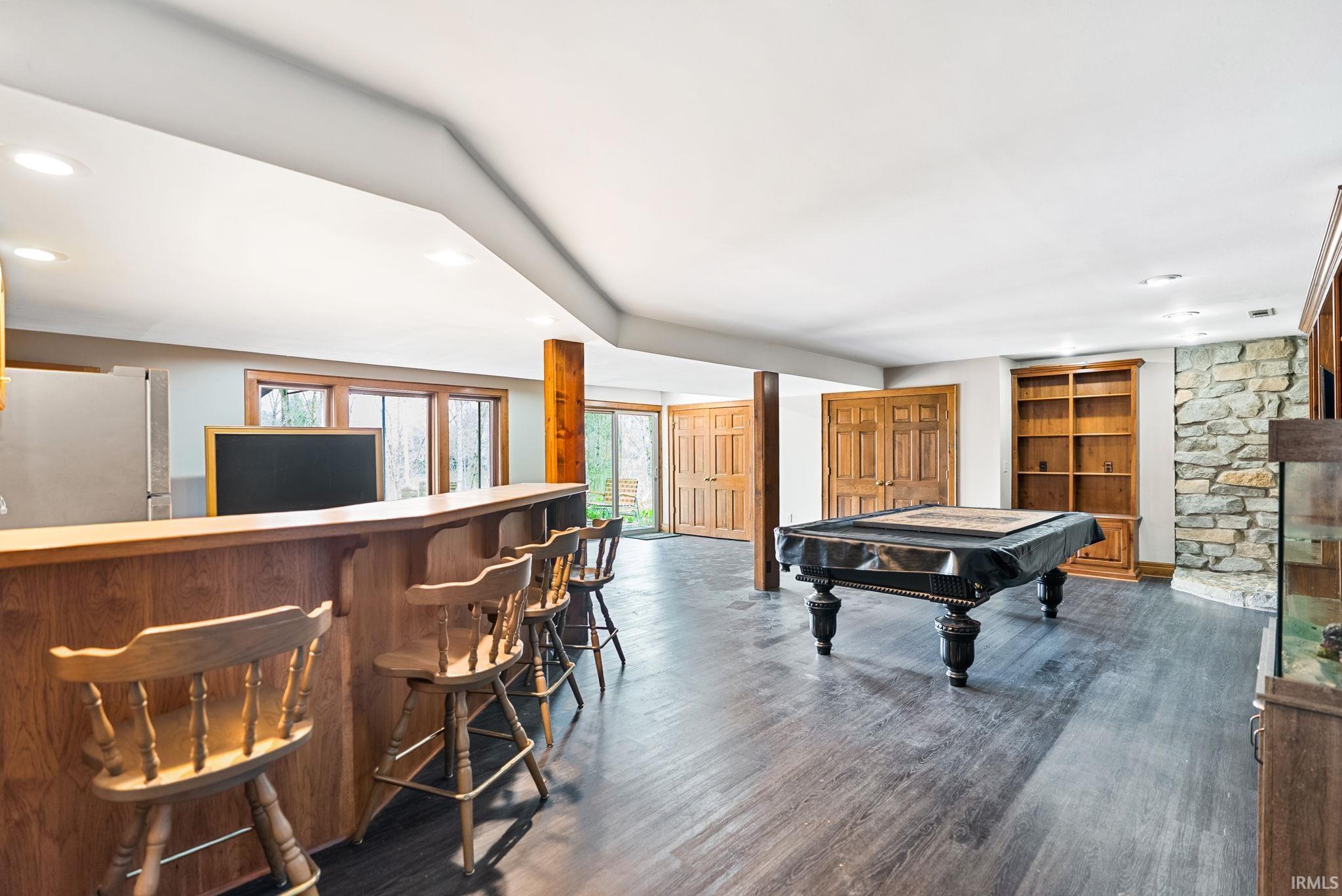 Game room with recessed lighting, billiards table, a bar, and dark wood-type flooring