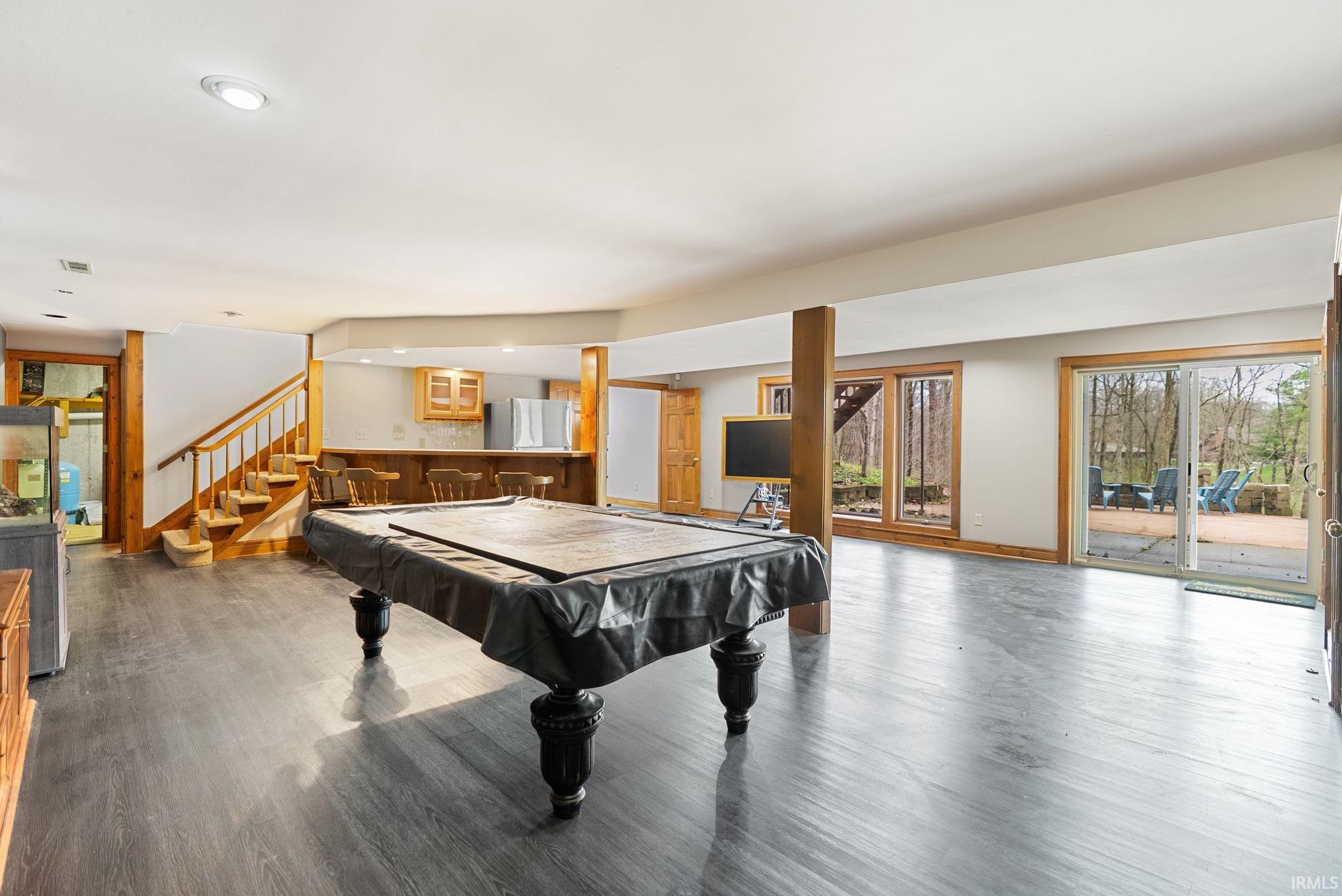 Playroom featuring pool table, dark wood finished floors, bar with sink, and recessed lighting