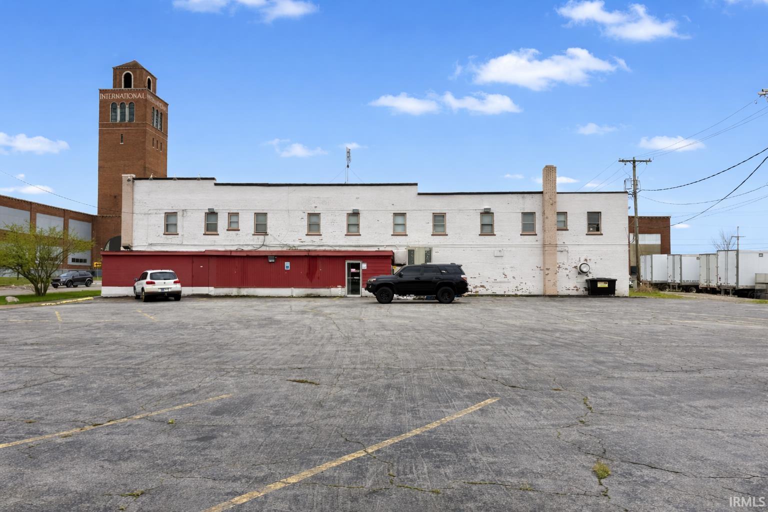 View of property with uncovered parking