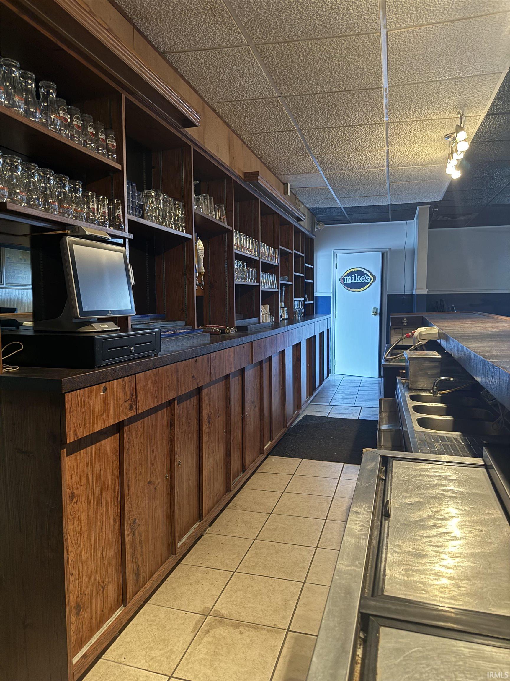 Kitchen featuring dark countertops and a drop ceiling