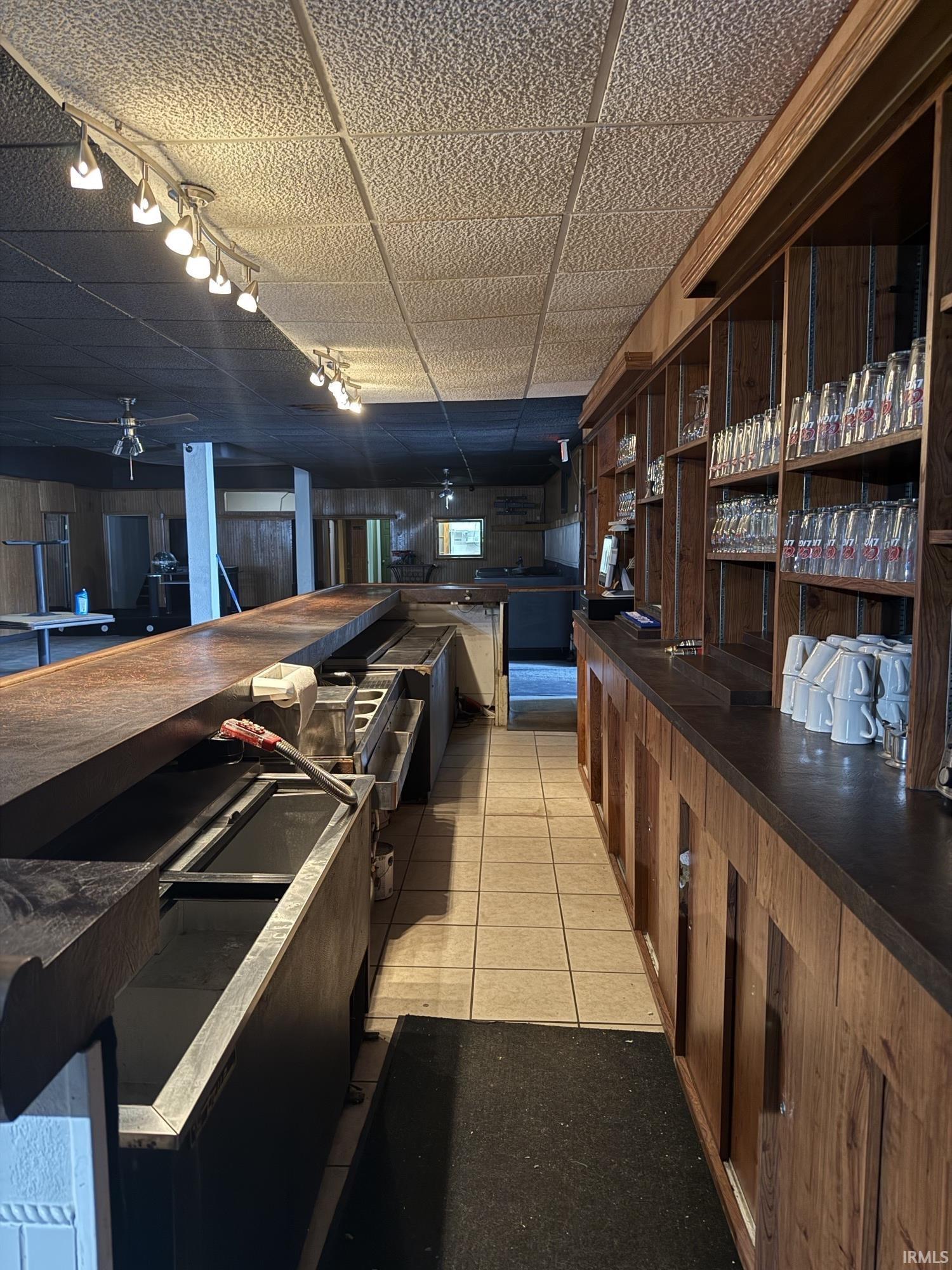 Bar featuring a paneled ceiling and butcher block countertops