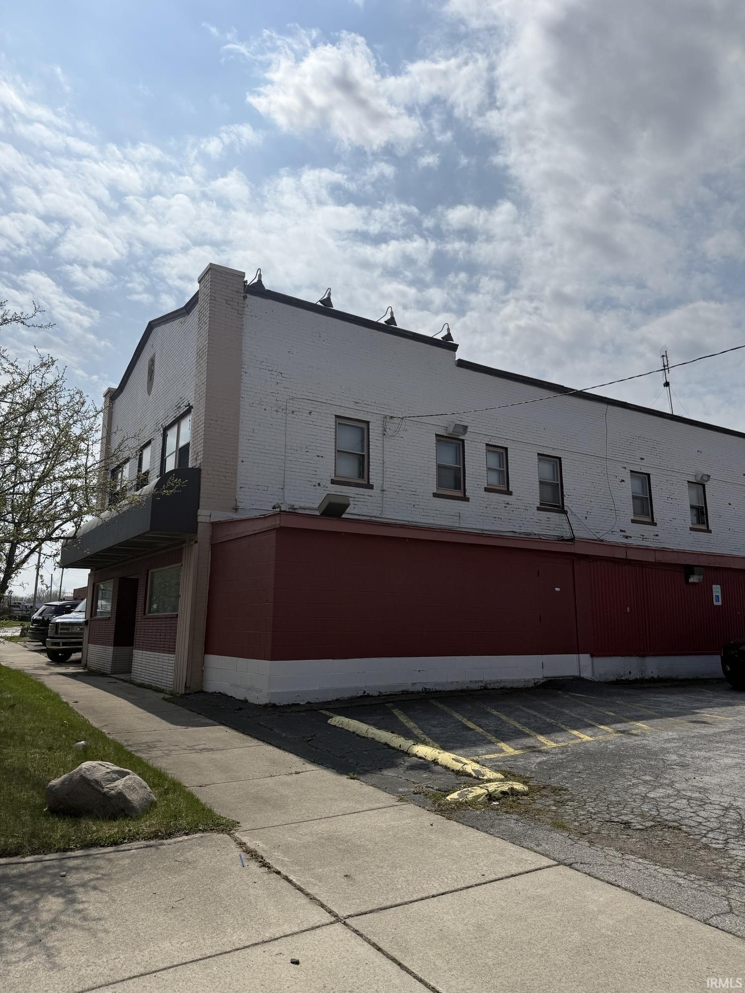View of building exterior featuring uncovered parking
