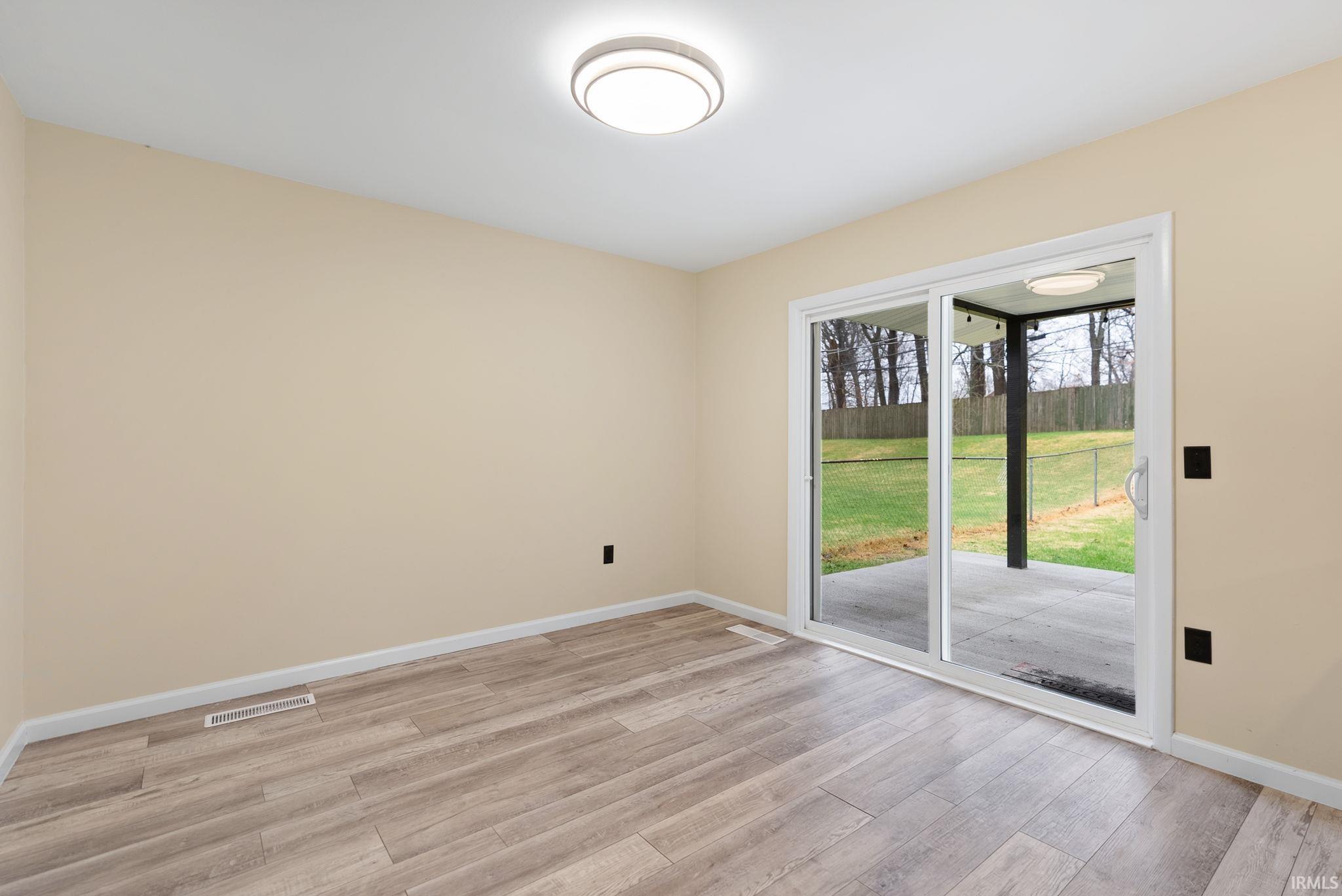 Unfurnished room featuring baseboards and light wood-style floors