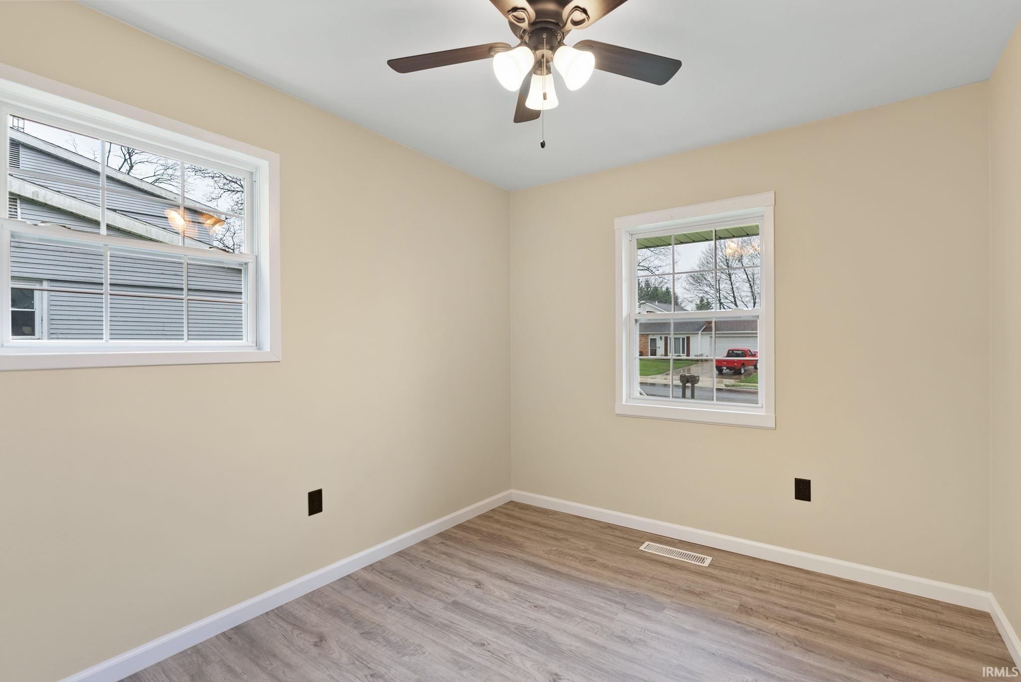 Spare room featuring light wood-type flooring and ceiling fan