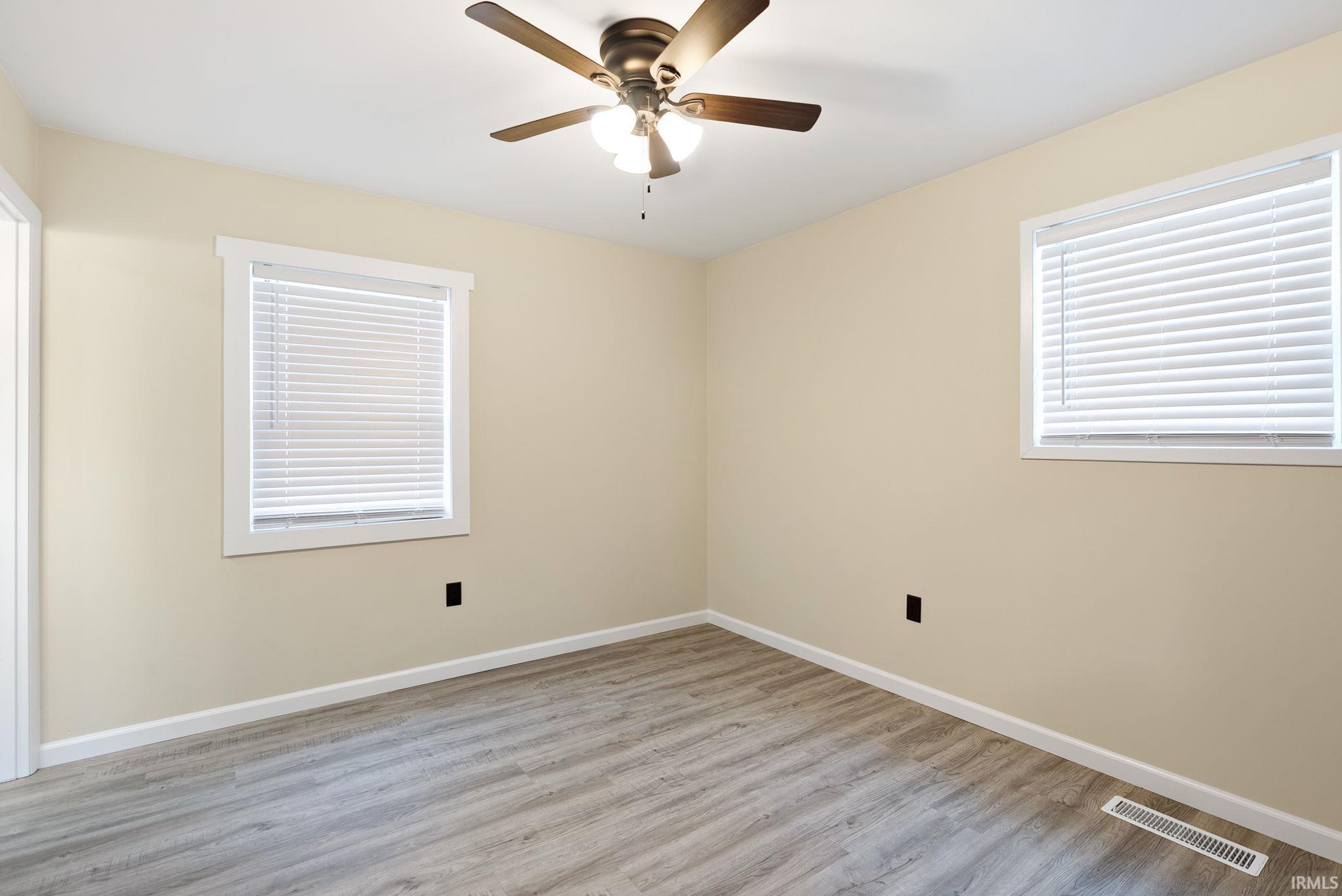 Spare room with light wood-type flooring and a ceiling fan
