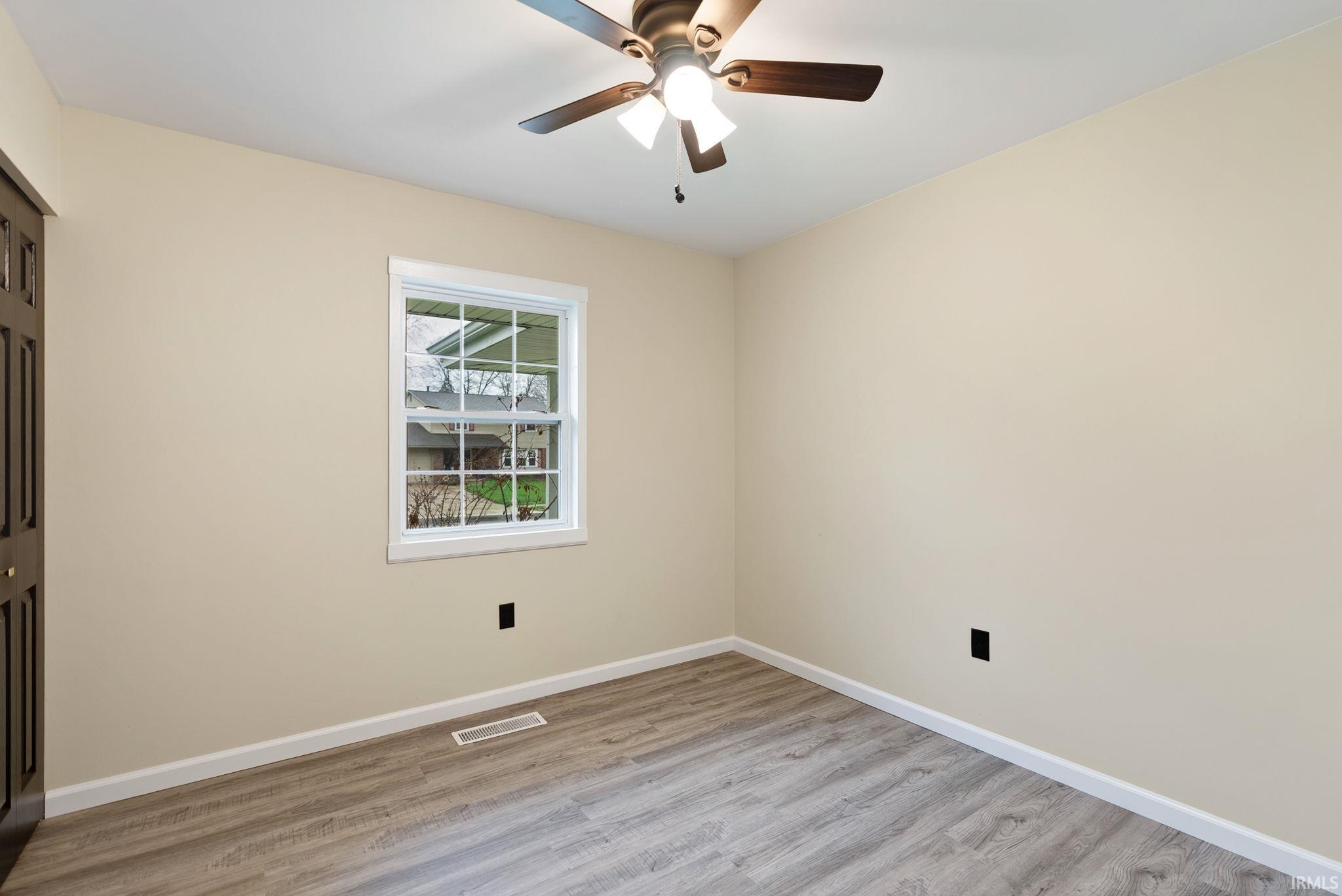 Spare room featuring light wood finished floors and a ceiling fan