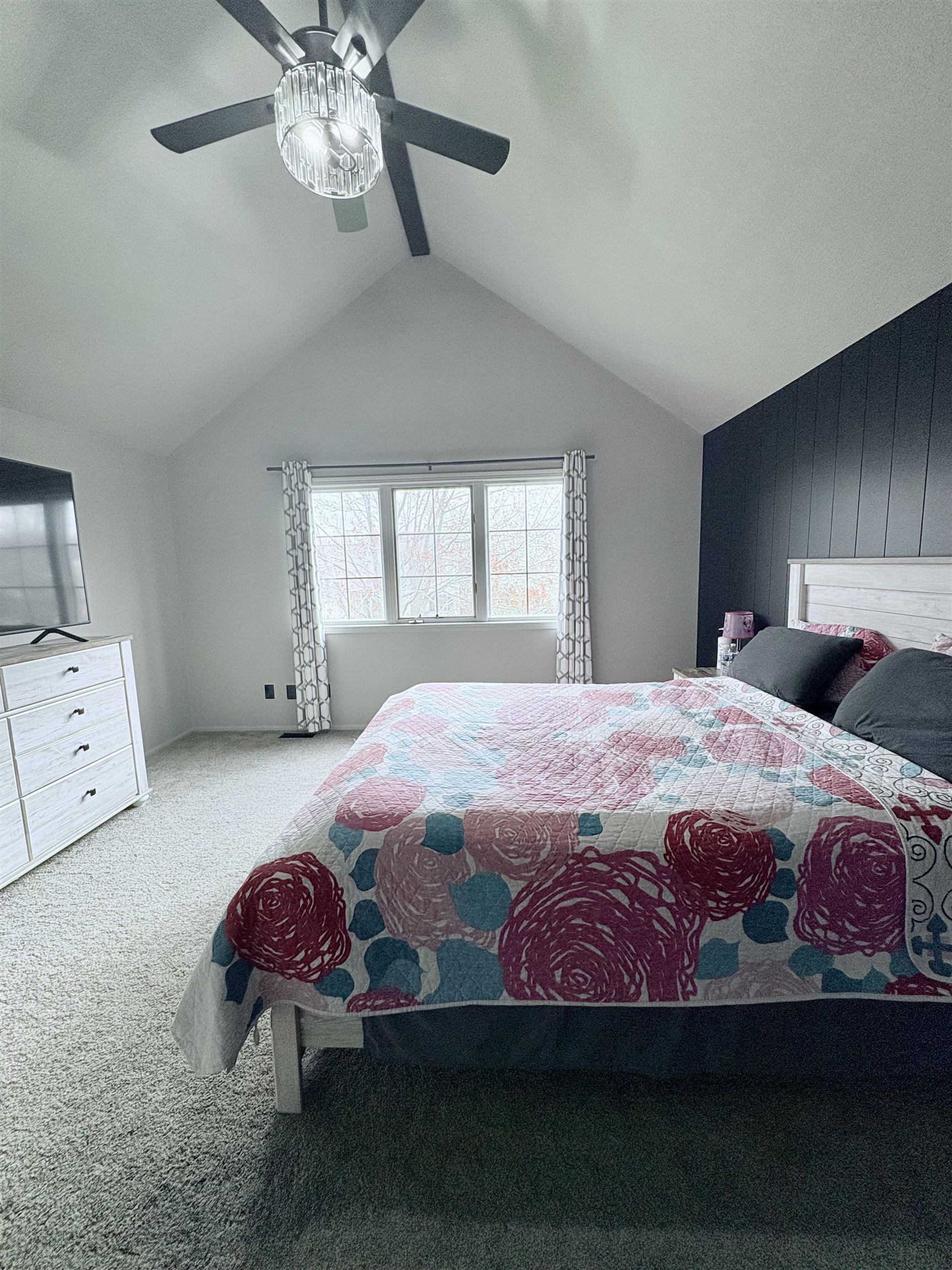 Bedroom featuring carpet floors, a ceiling fan, and beam ceiling