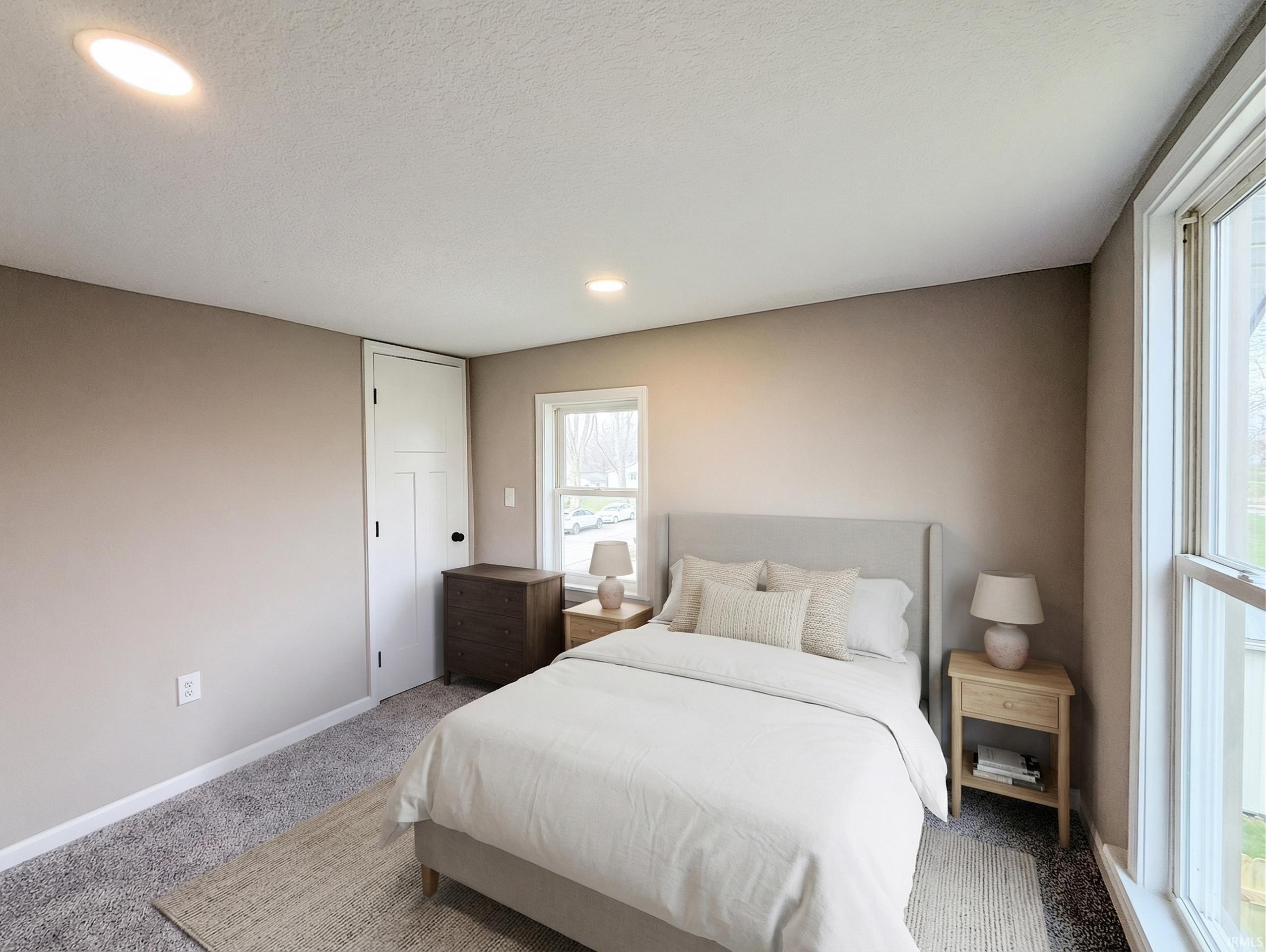 Bedroom with carpet flooring, recessed lighting, and a textured ceiling