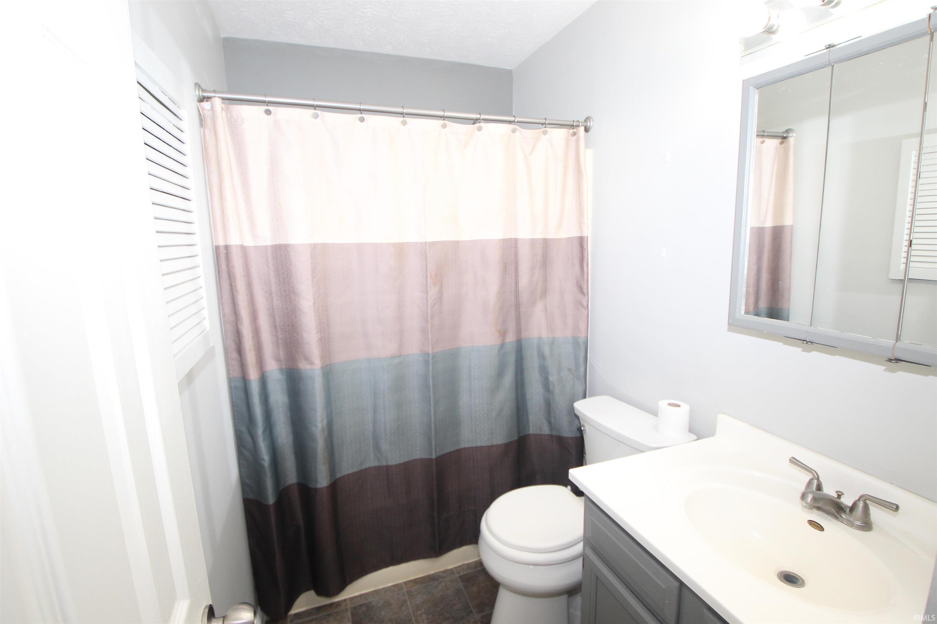 Bathroom featuring vanity and a shower with curtain
