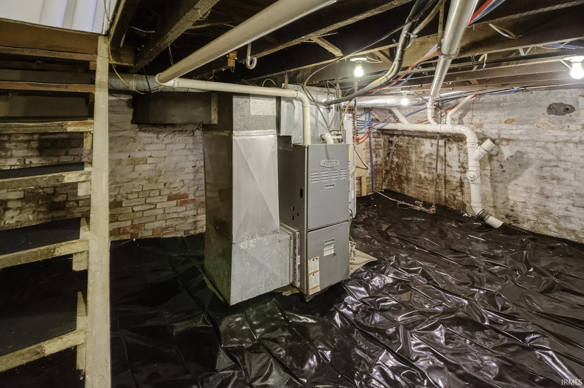Unfinished below grade area with heating unit