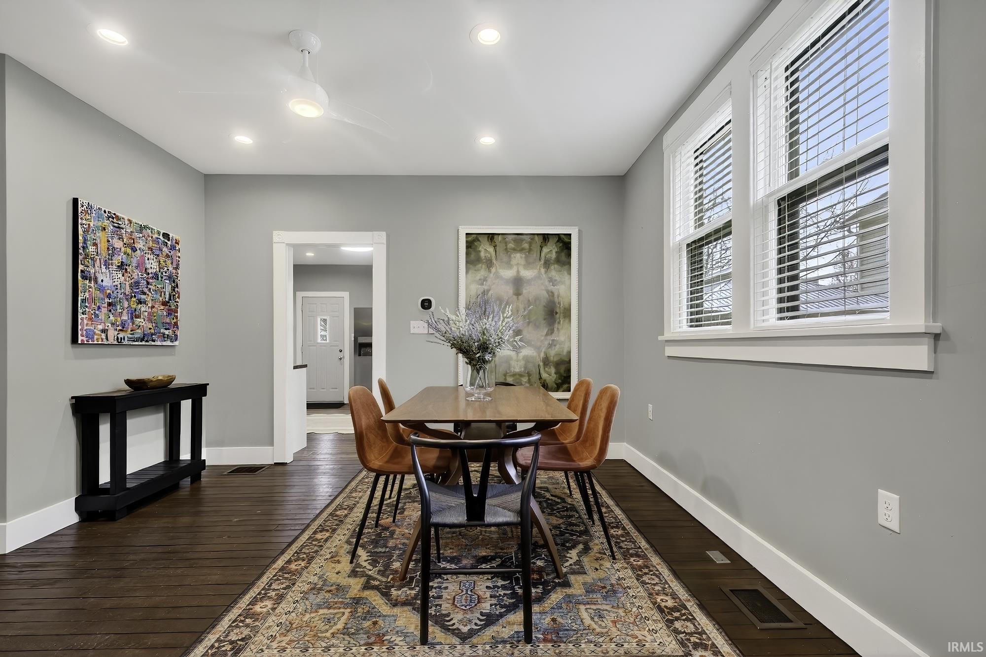 Dining room featuring dark wood-type flooring, recessed lighting, and a ceiling fan