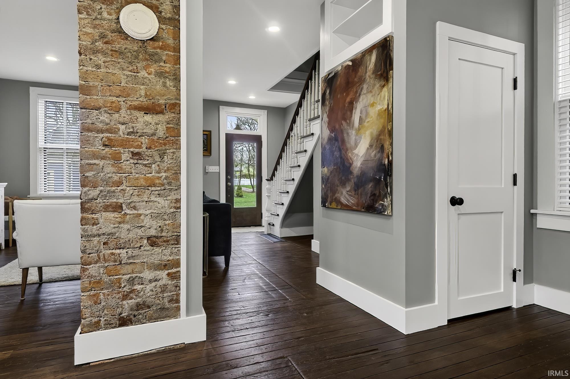 Foyer entrance with dark wood-style floors and recessed lighting