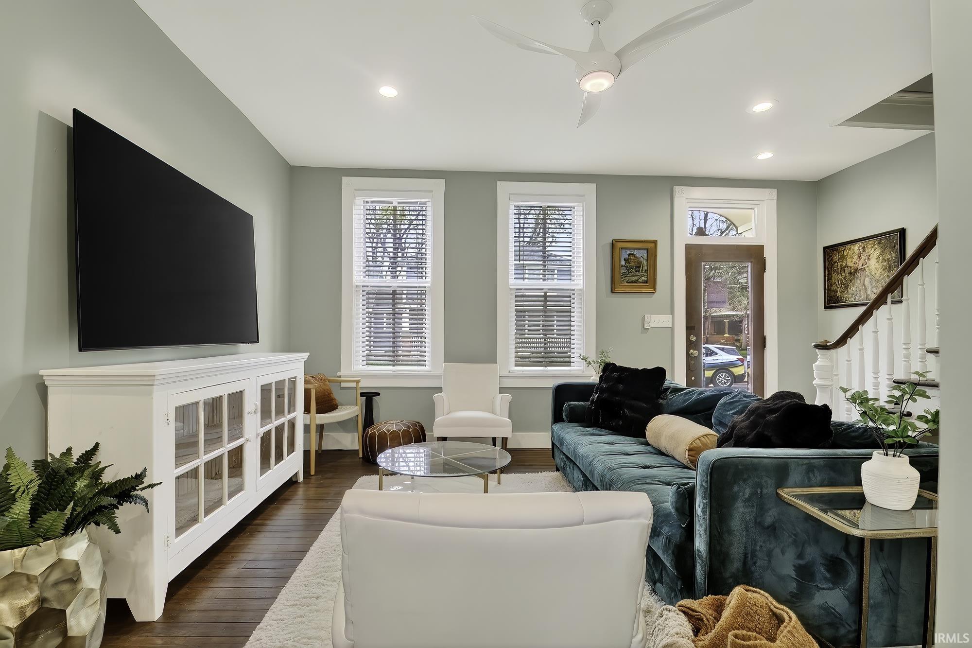 Living room featuring a ceiling fan, dark wood finished floors, and recessed lighting