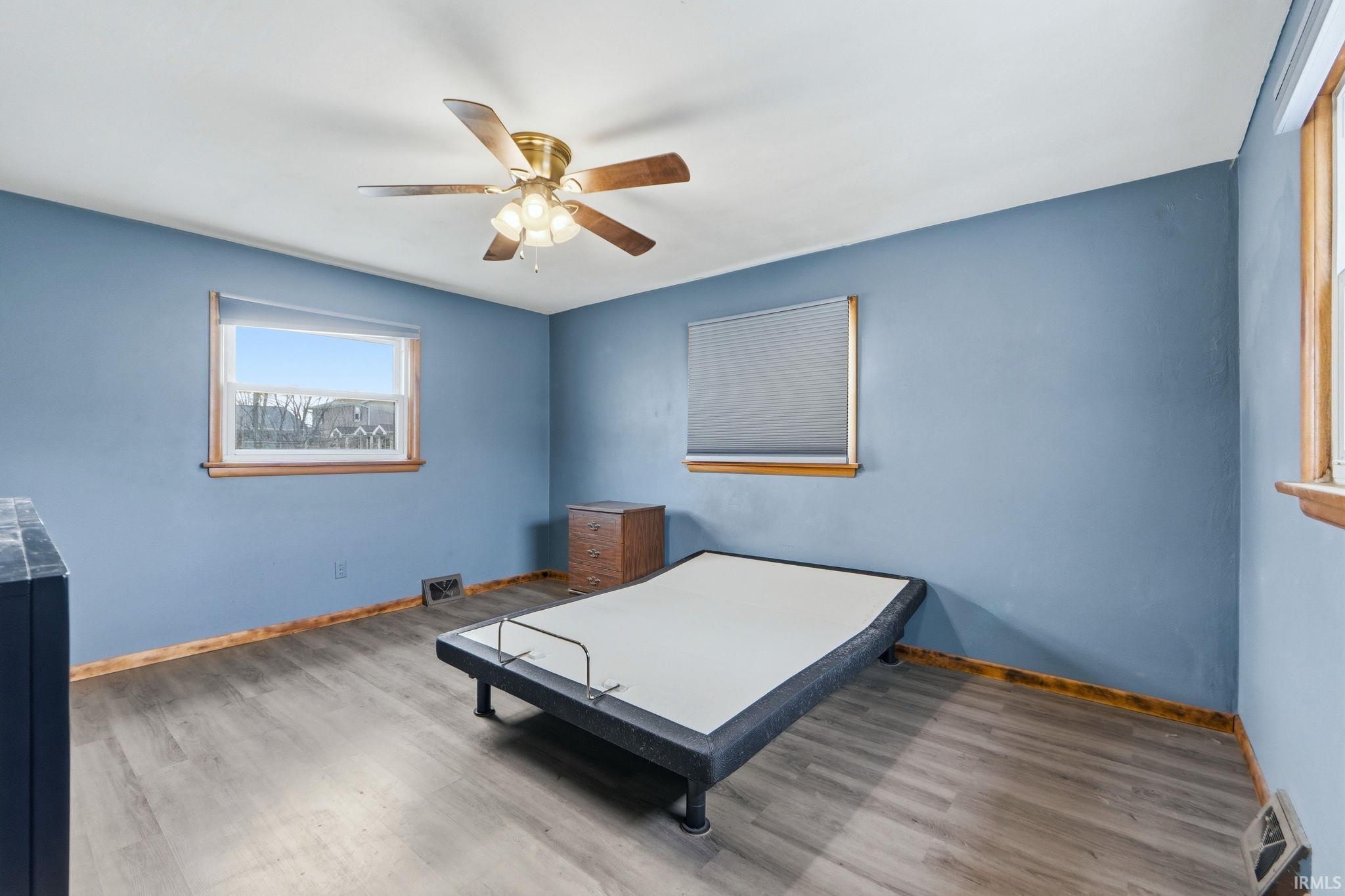 Bedroom with wood finished floors and ceiling fan