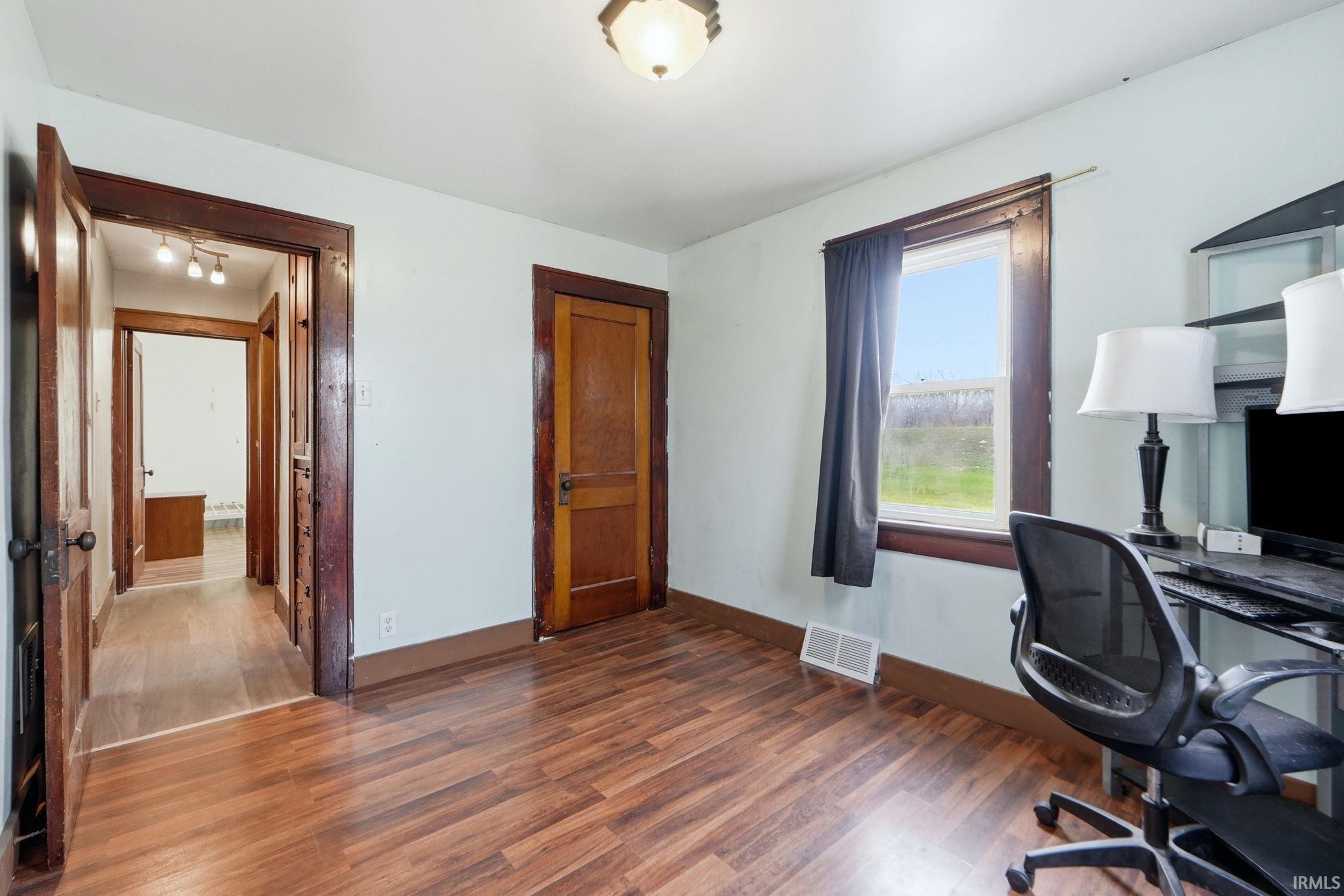 Office area featuring dark wood finished floors and baseboards
