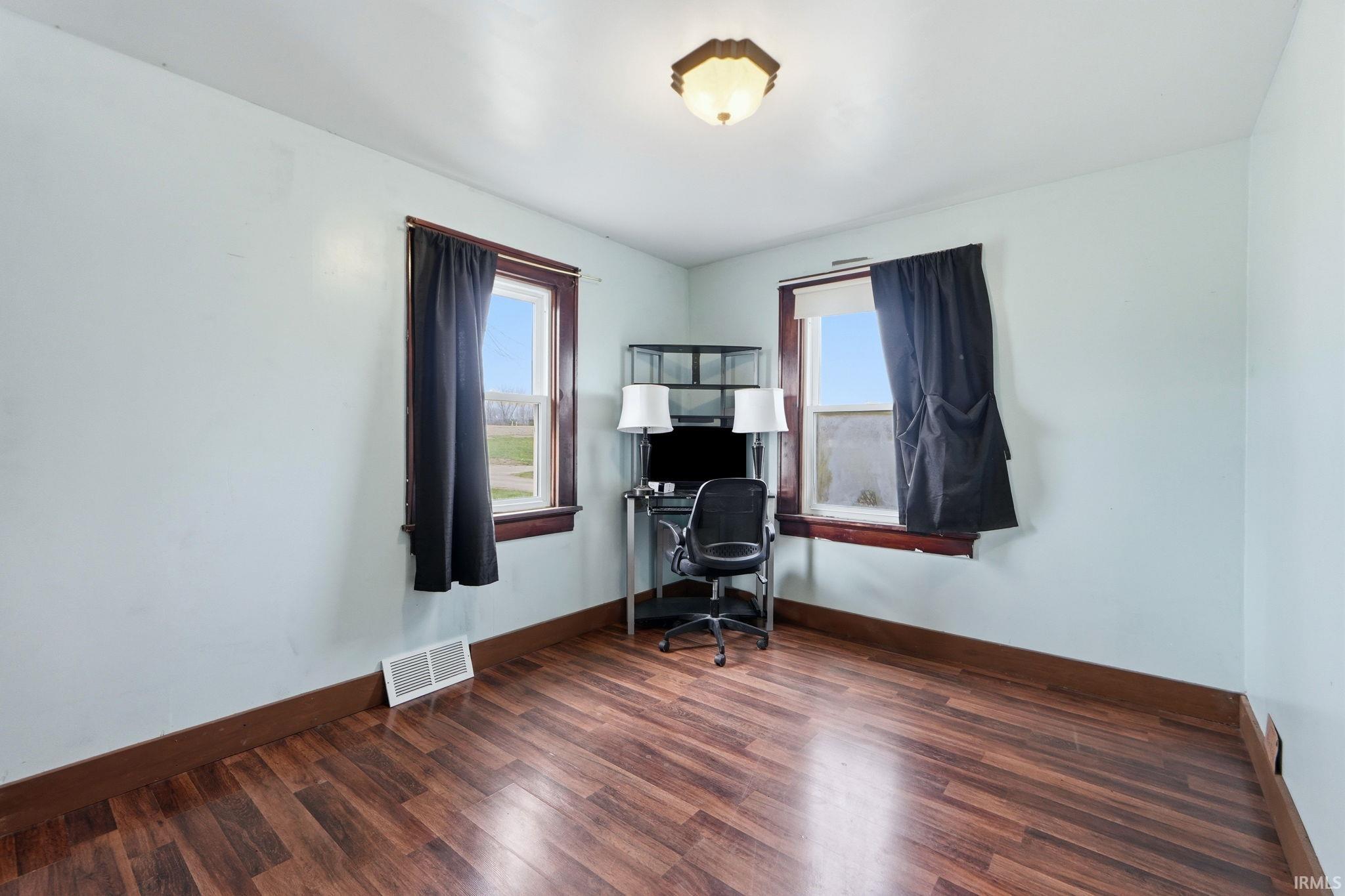 Office area with wood finished floors and baseboards