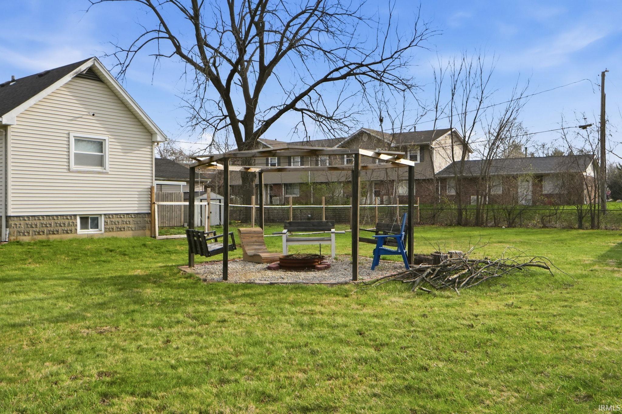 View of yard with a fire pit, a patio, and an outbuilding