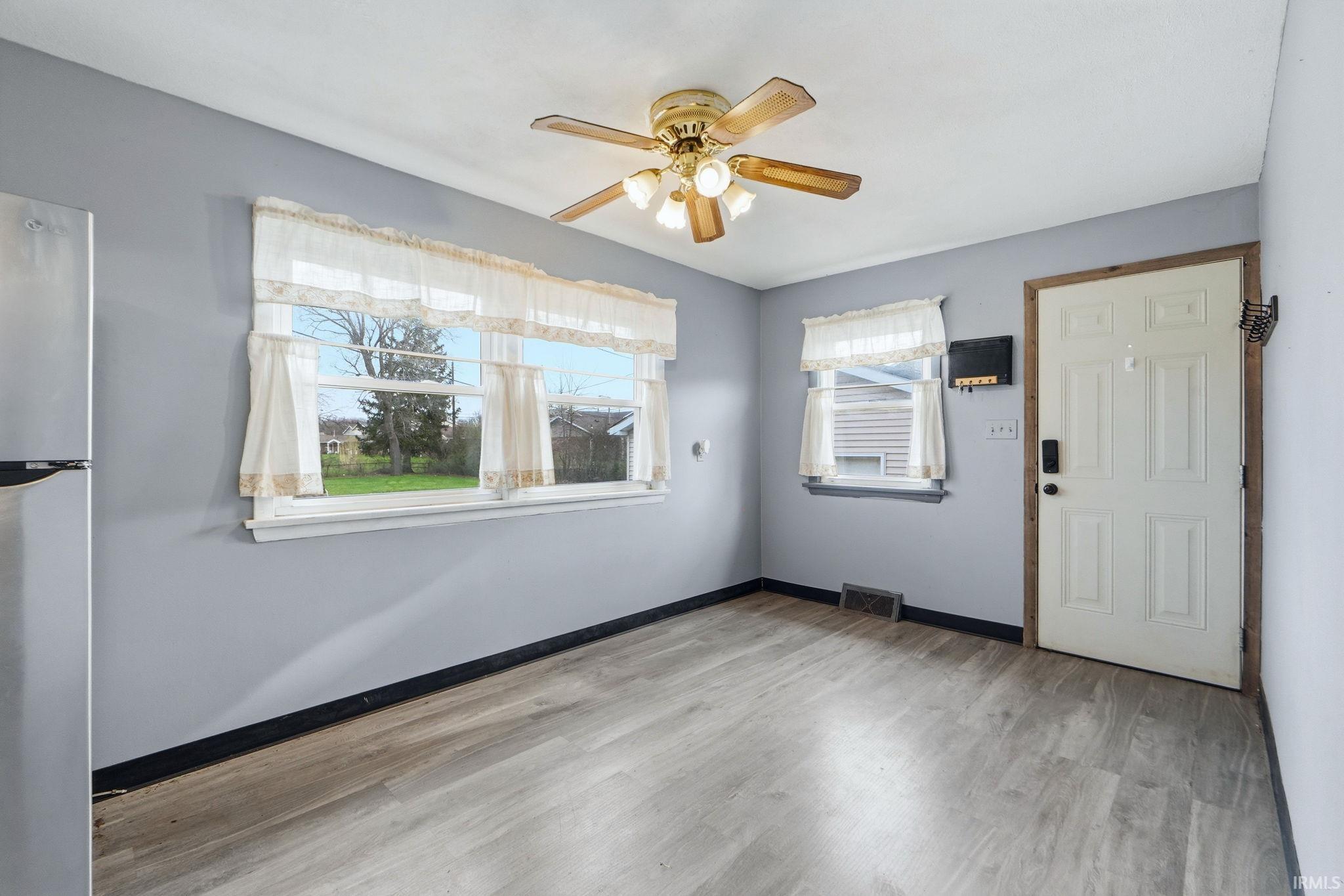 Foyer entrance featuring ceiling fan and light wood-style flooring