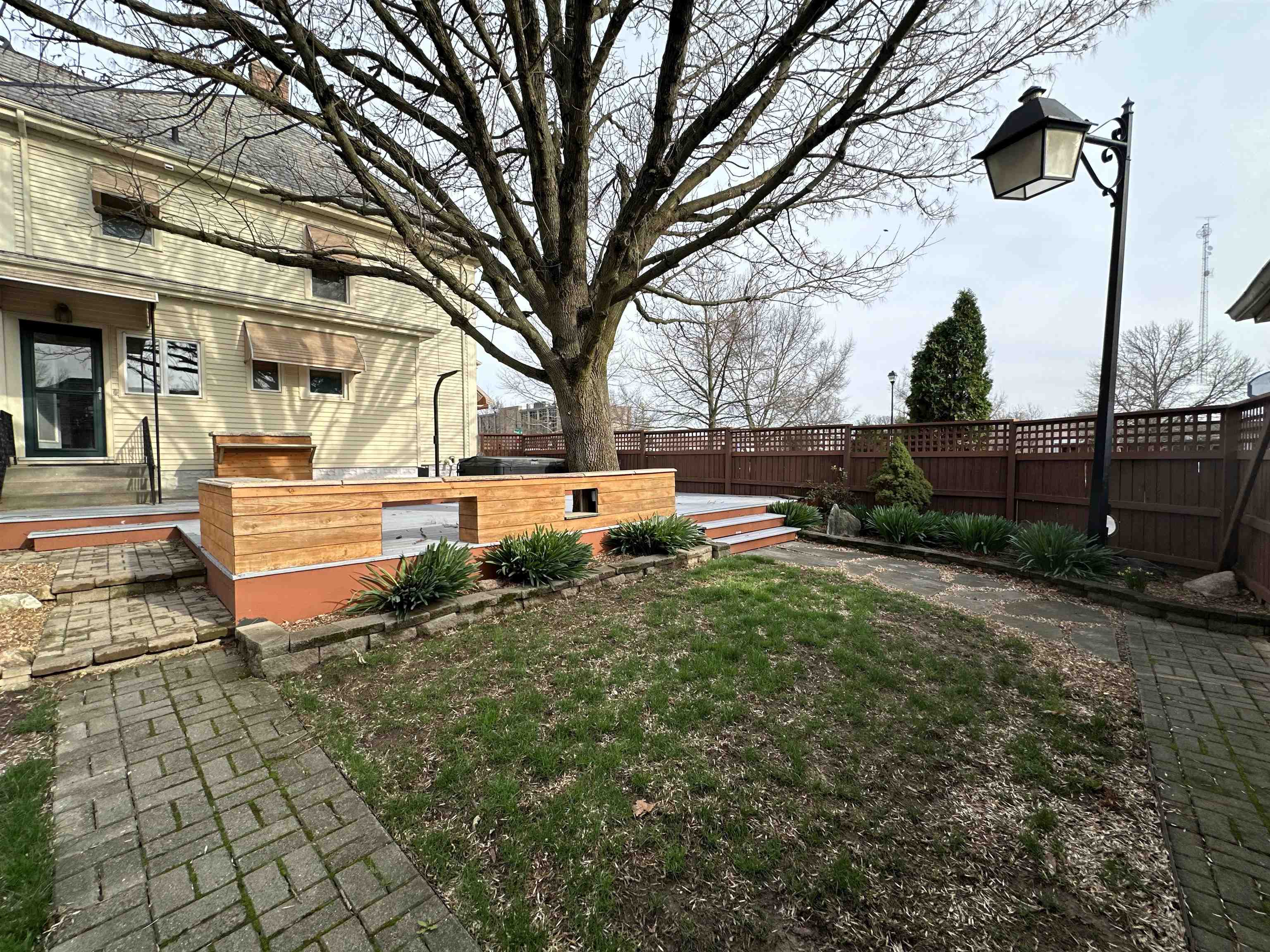 Fenced backyard featuring a deck and a patio area