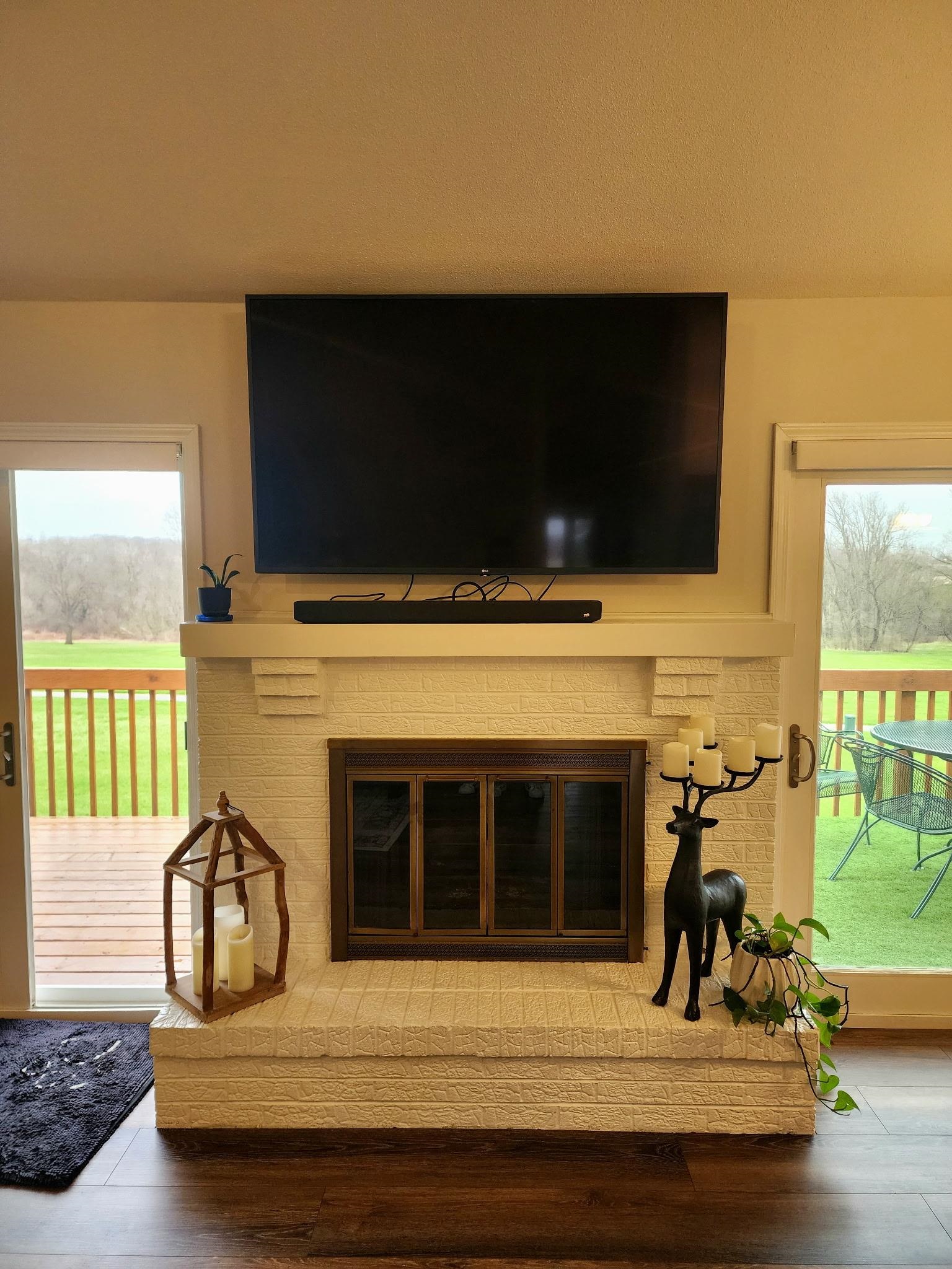 Detailed view of a fireplace and wood finished floors