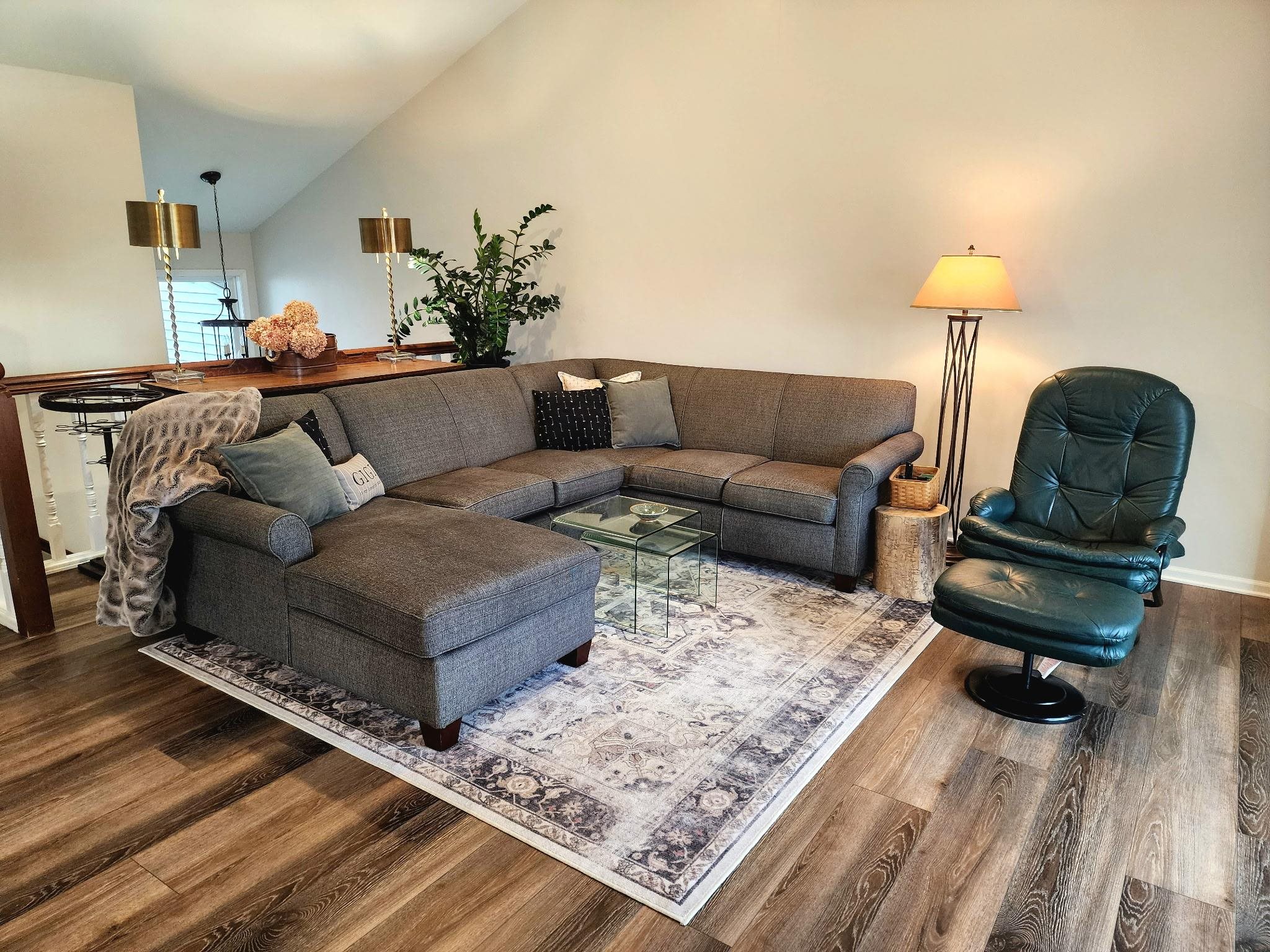 Living area with vaulted ceiling and wood finished floors