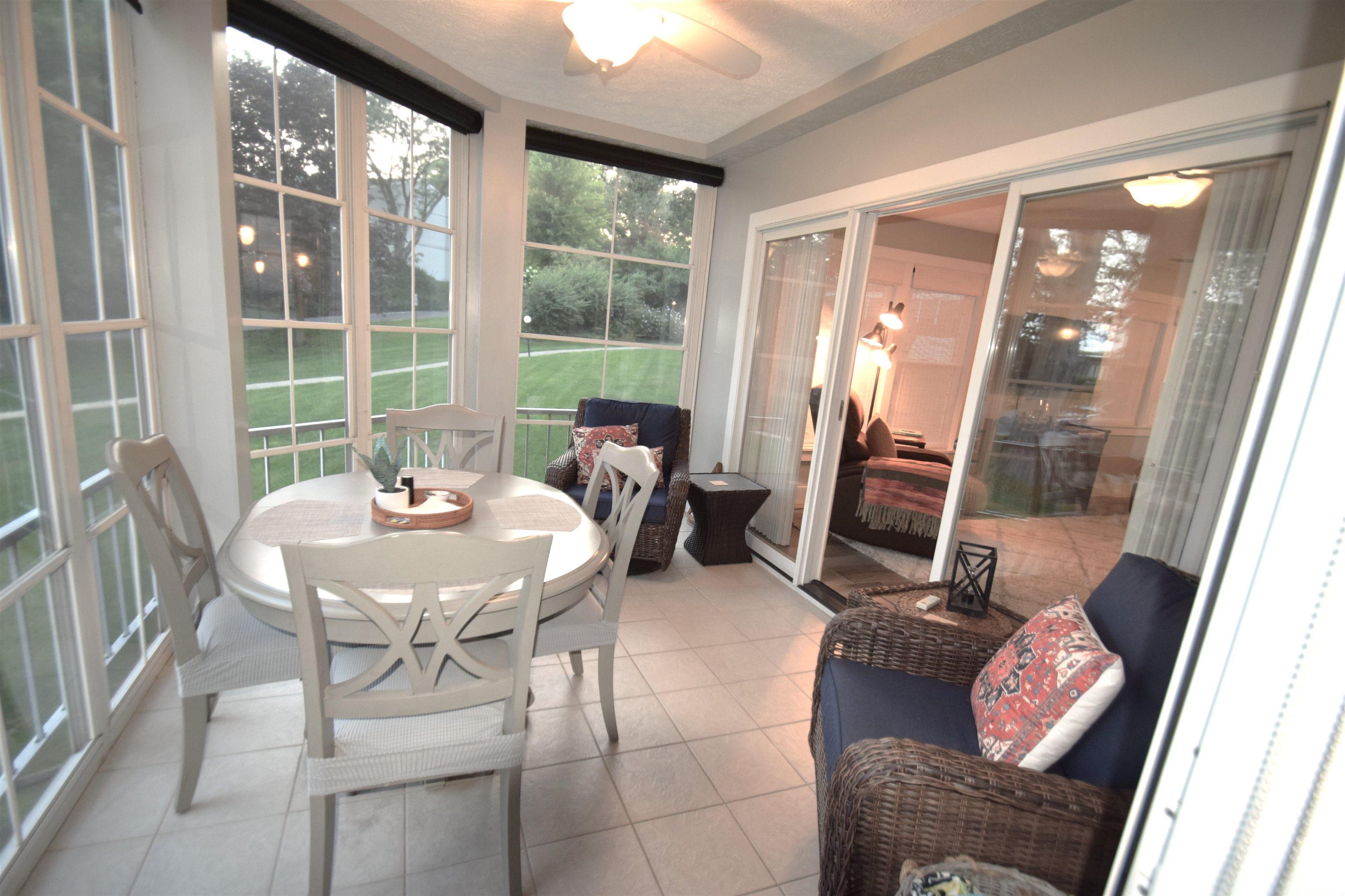 Sunroom / solarium with ceiling fan and outdoor dining area
