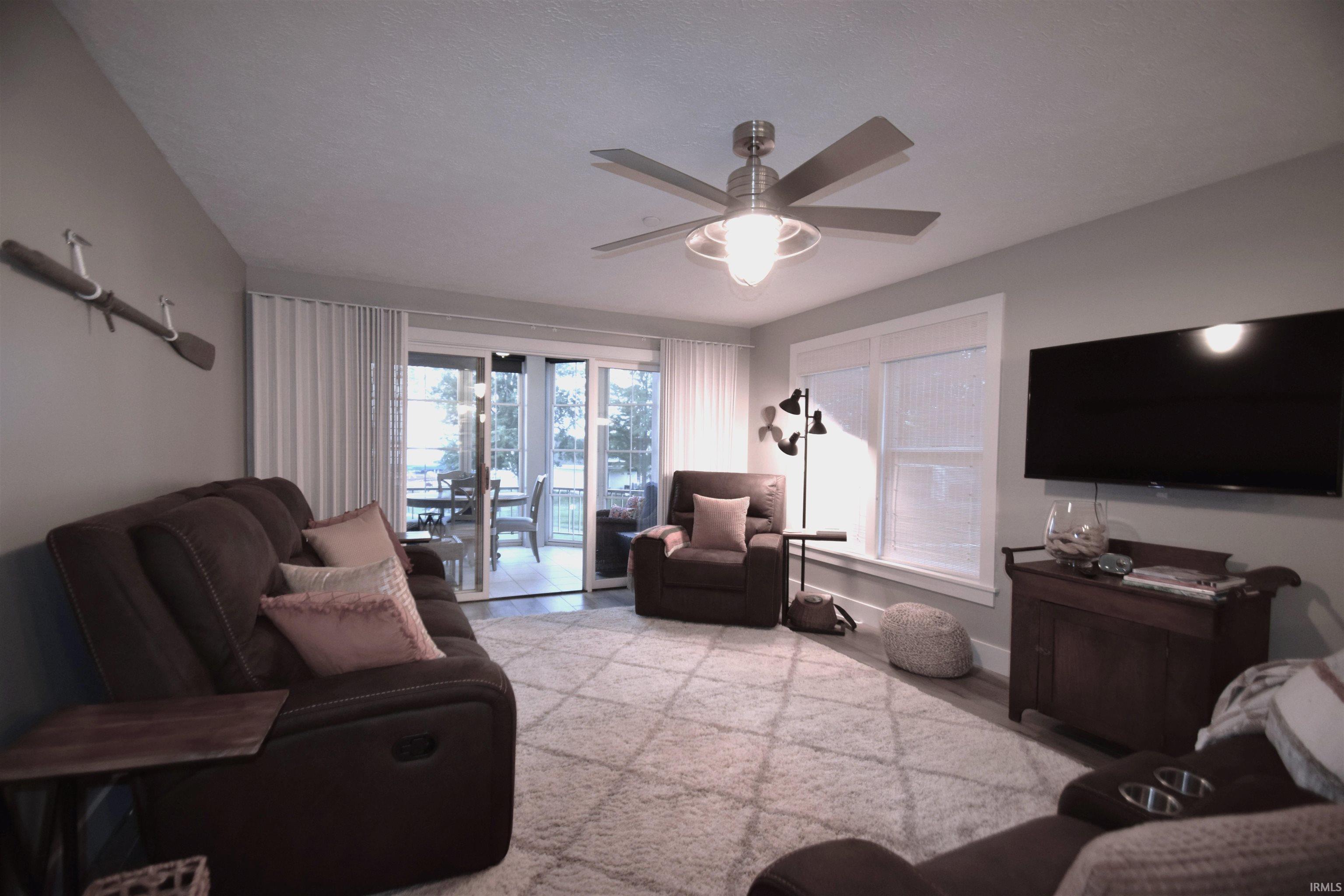Living area with a ceiling fan and light wood-type flooring