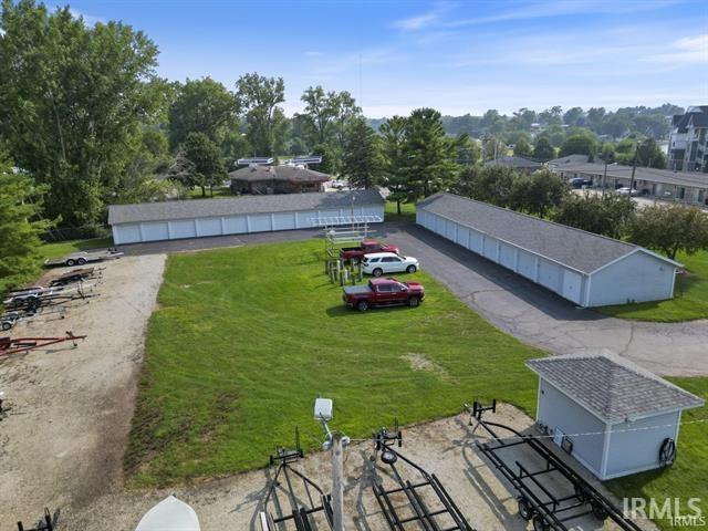 View of grassy yard with an outbuilding and view of wooded area