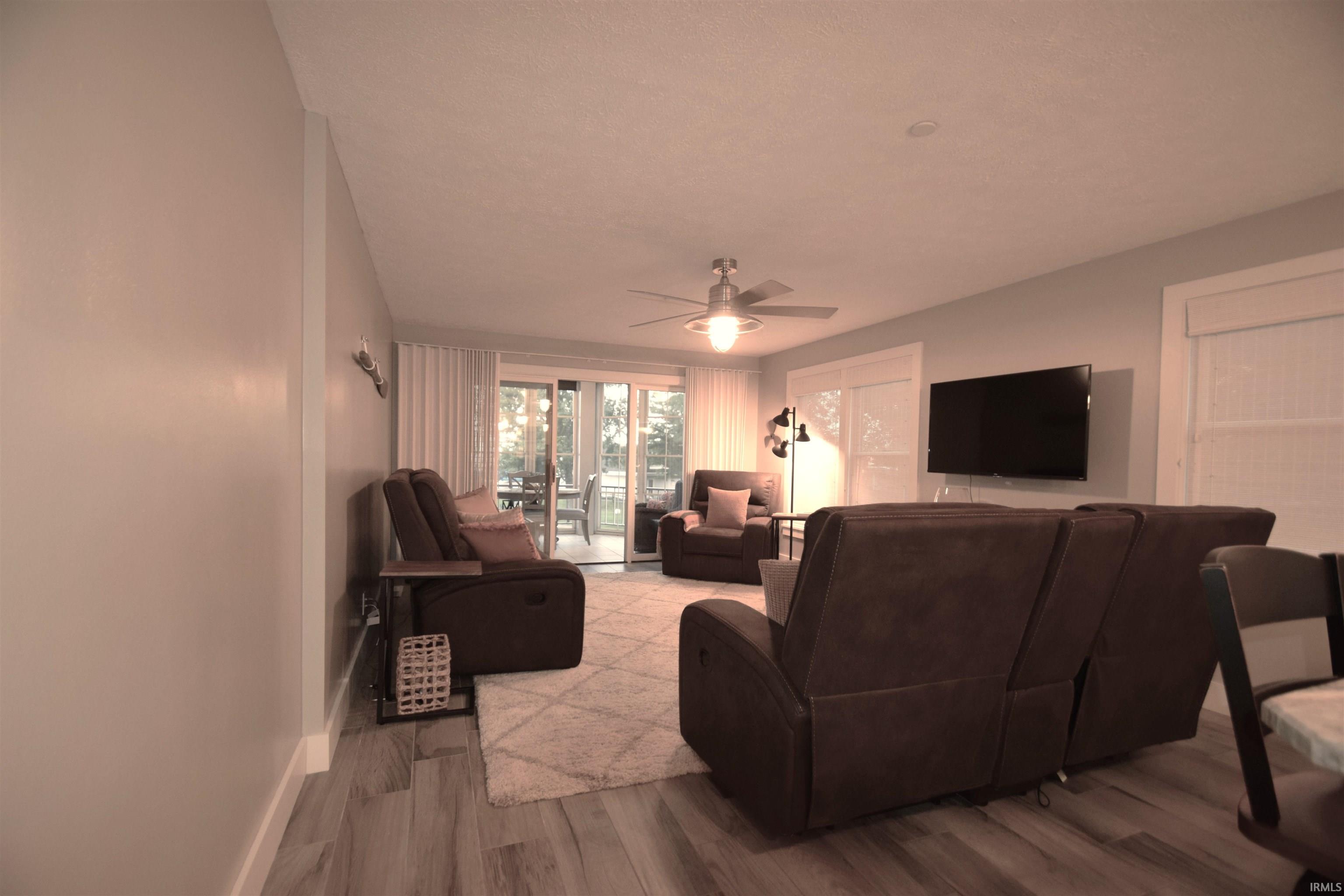 Living area with wood finished floors and a ceiling fan