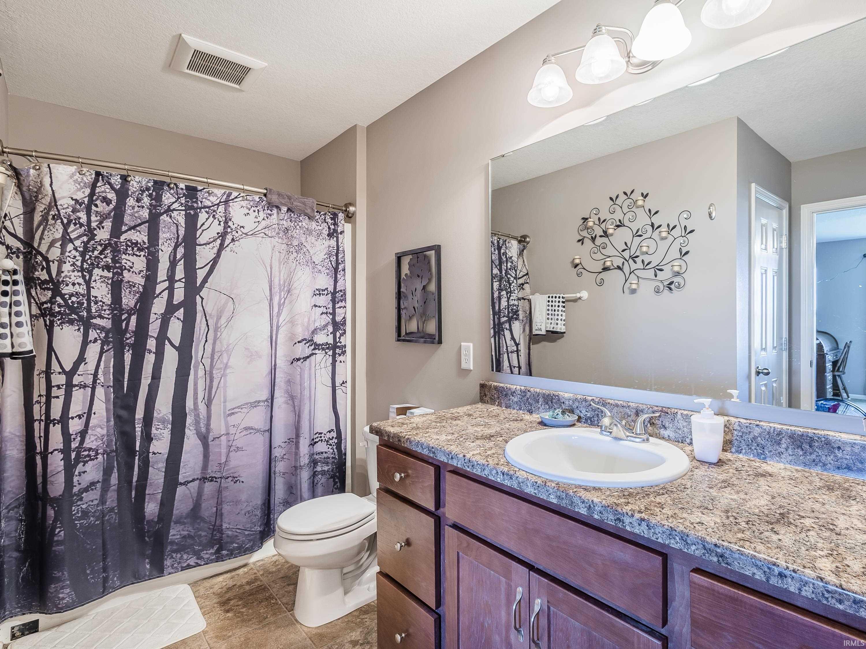 Full bath featuring vanity and toilet