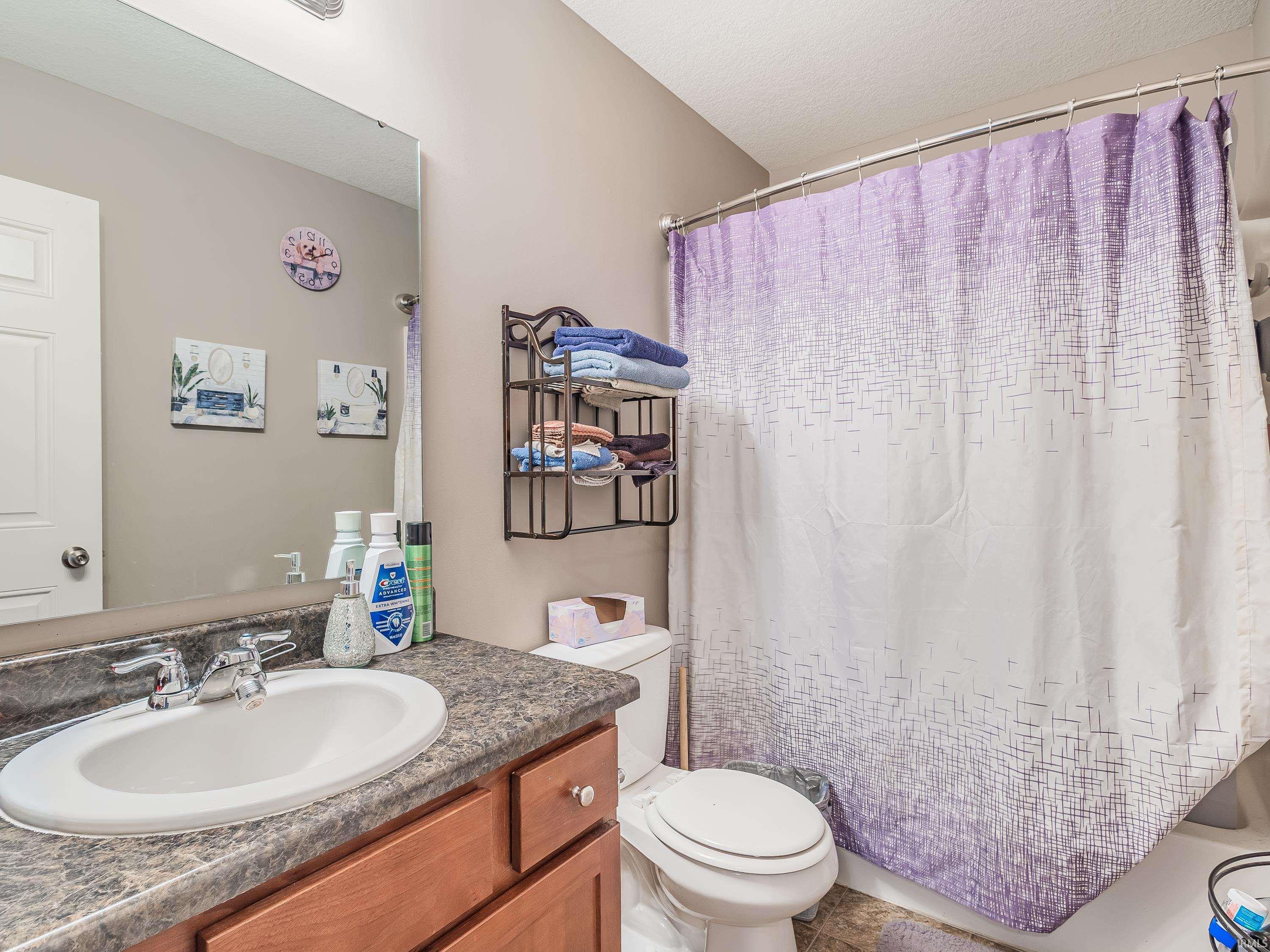 Bathroom with vanity and a shower with shower curtain