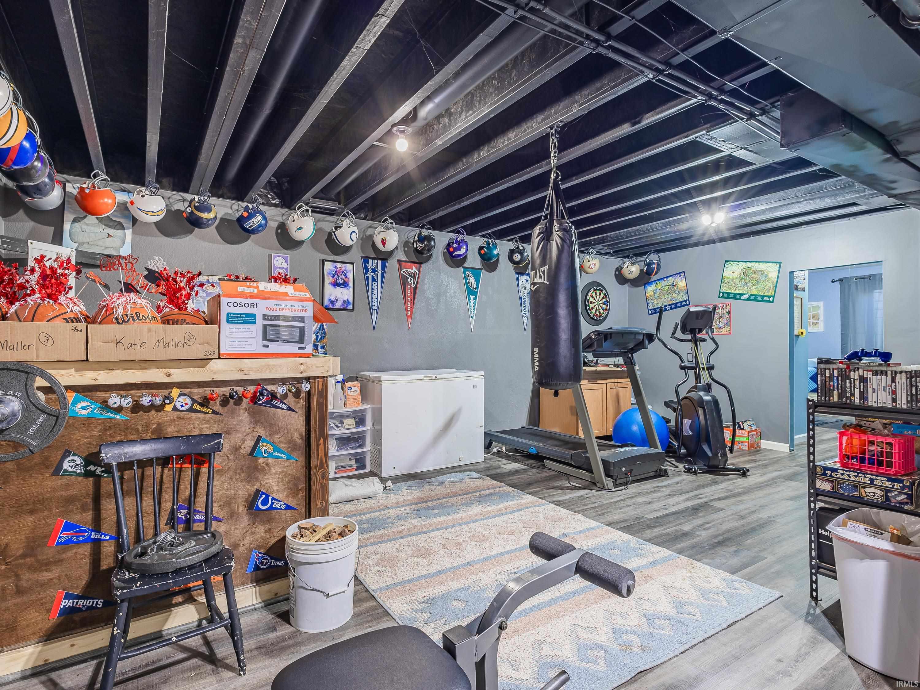 Exercise area featuring light wood-style flooring and baseboards