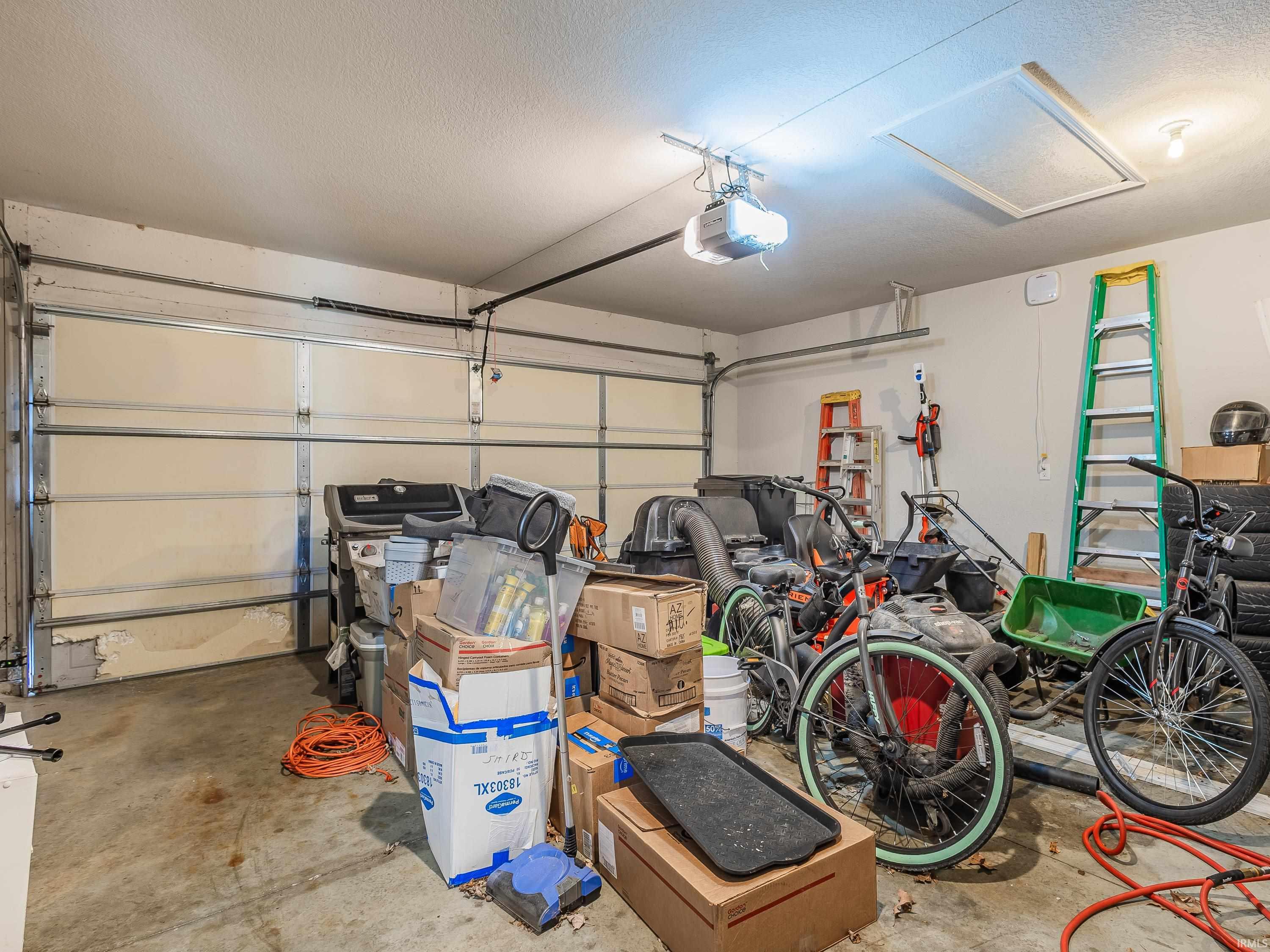 Garage featuring a garage door opener