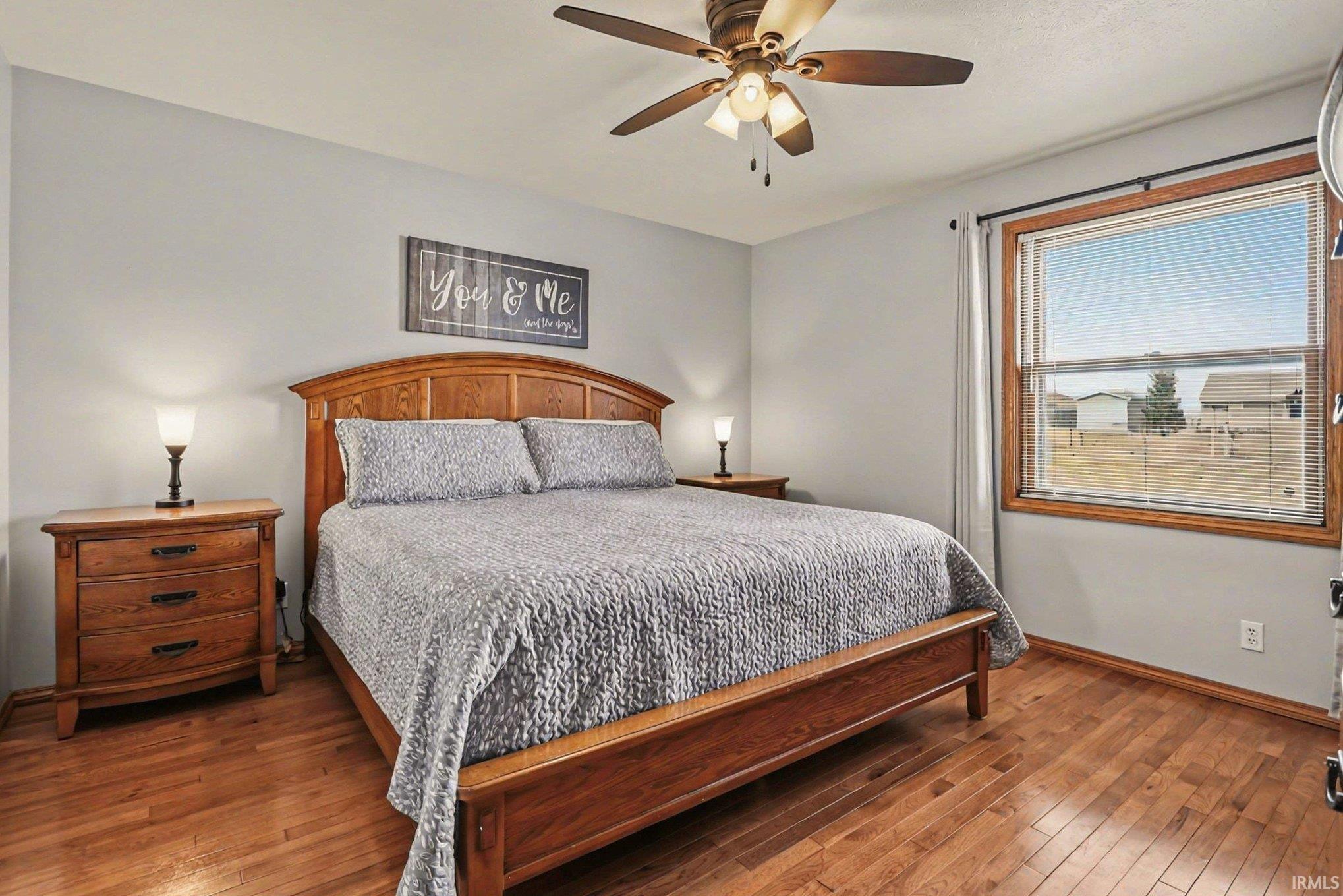 Bedroom featuring hardwood / wood-style floors and a ceiling fan