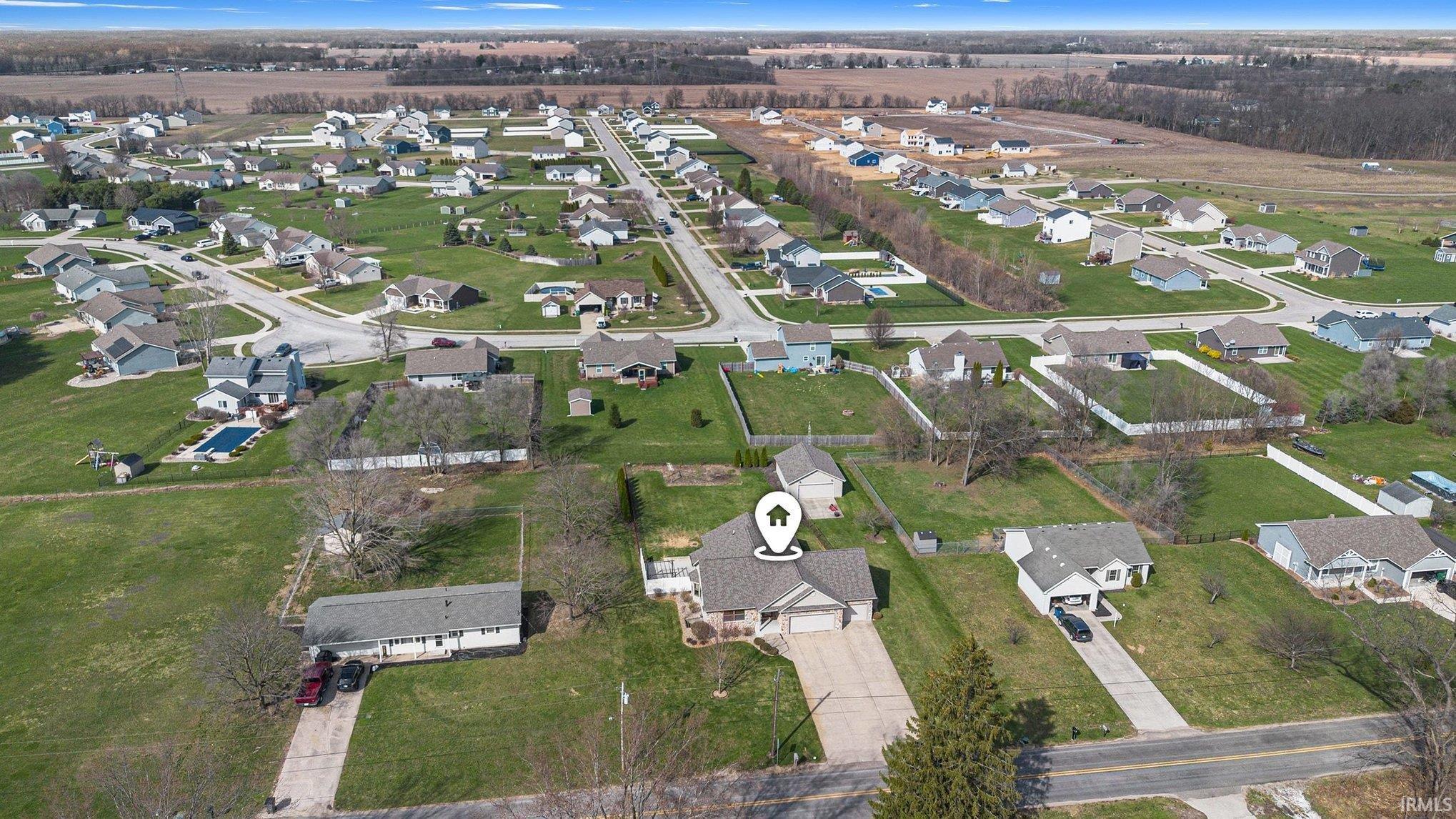 Aerial view of property and surrounding area with nearby suburban area