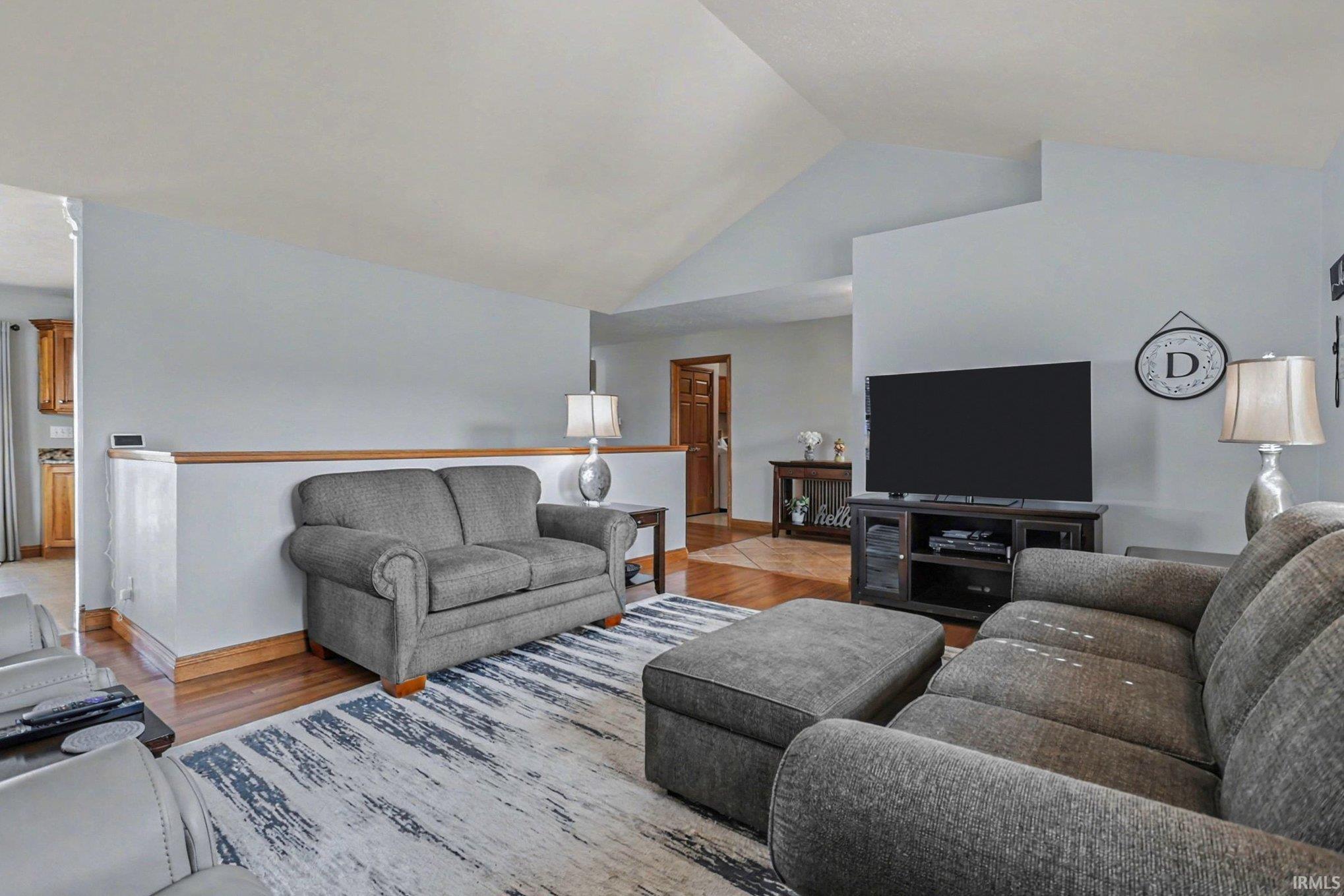 Living room featuring light wood-type flooring and a high ceiling