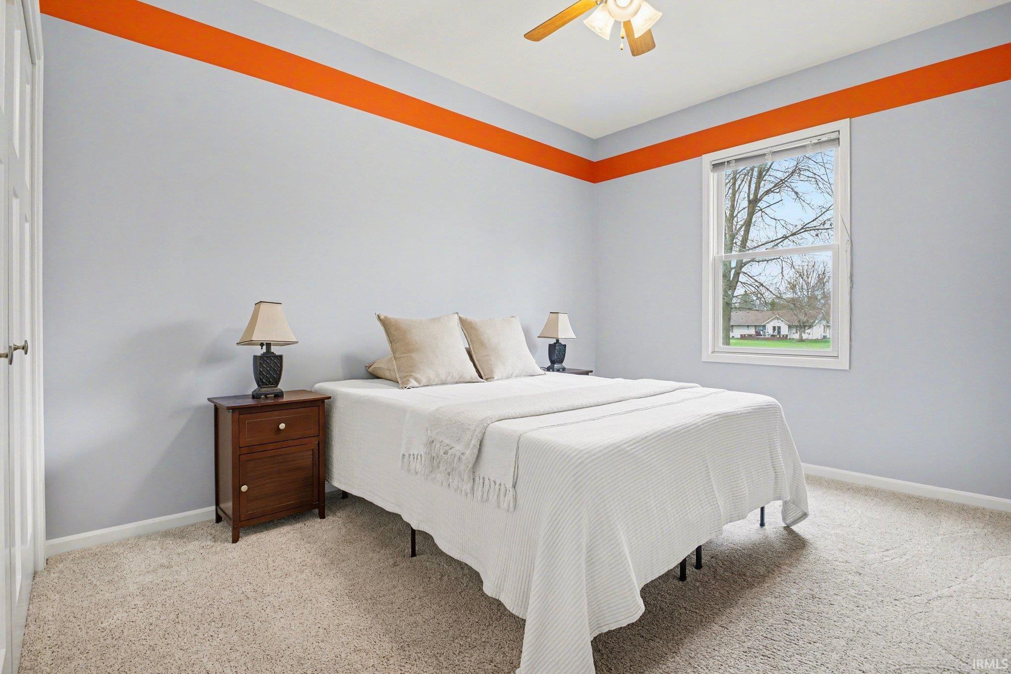 Bedroom with light carpet and ceiling fan