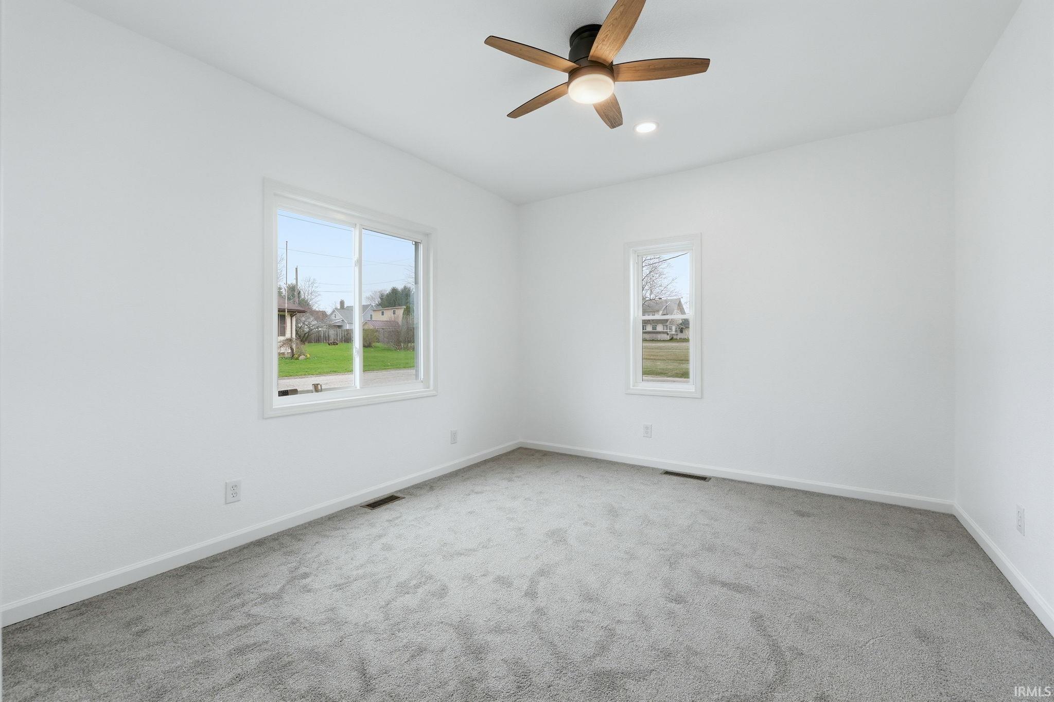 Empty room featuring carpet floors and ceiling fan