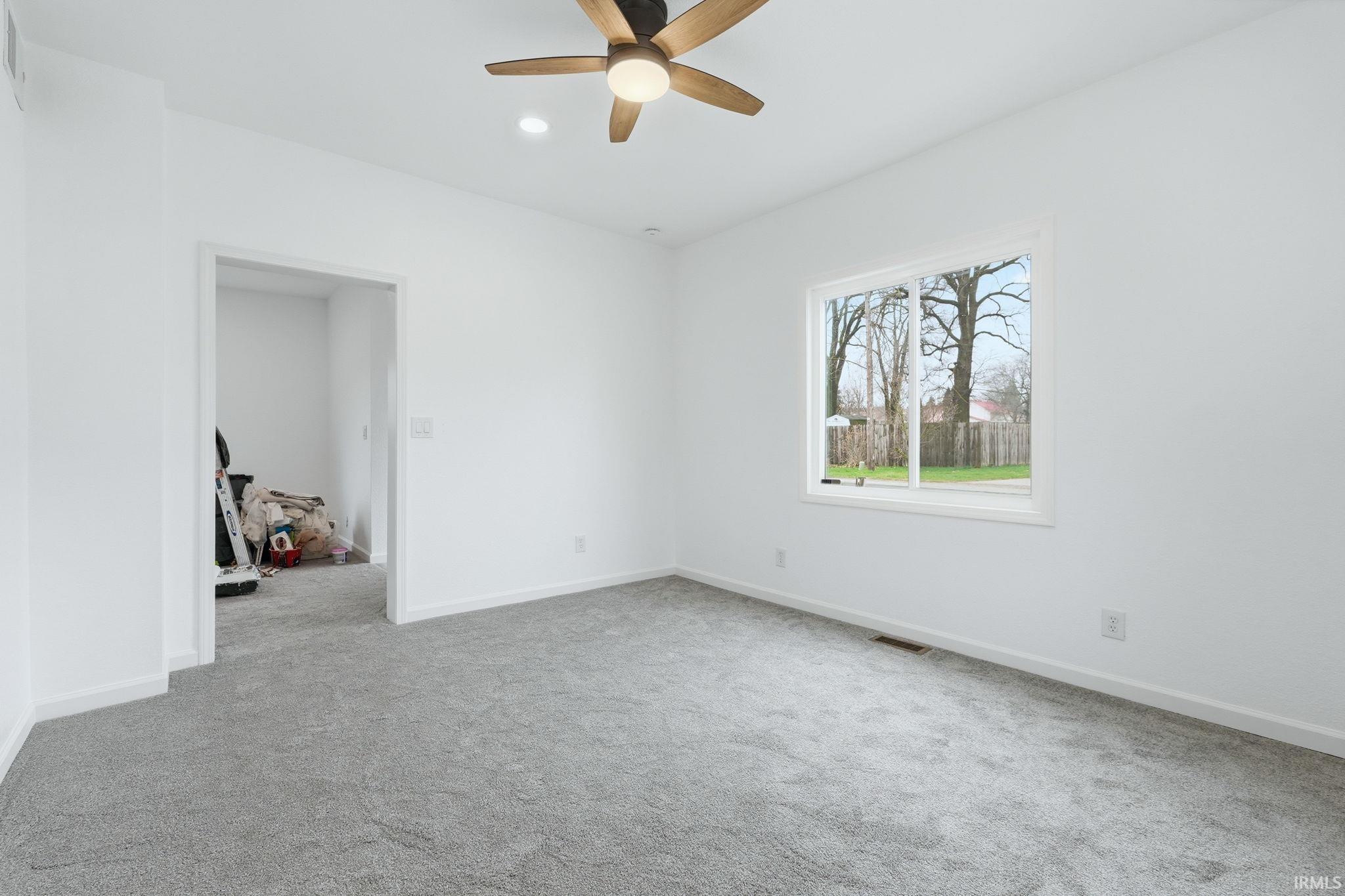 Unfurnished room featuring light colored carpet, ceiling fan, and recessed lighting